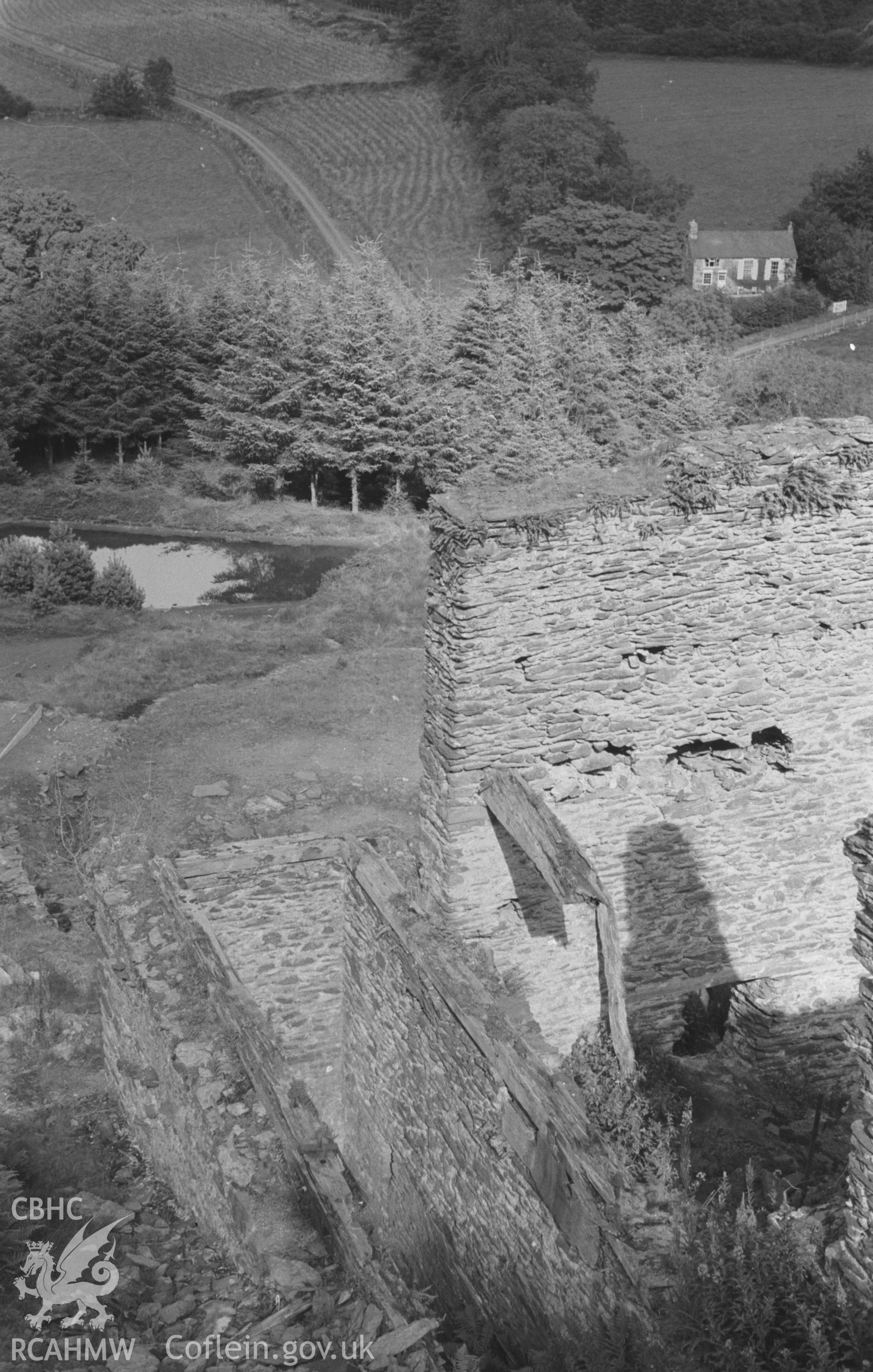 Digital copy of black & white negative showing view from the ruins of Ystrad Einion mine to the converted Capel Cwm-Einion, south east of Furnace, Machynlleth. Photographed by Arthur O. Chater in August 1965 from Grid Reference SN 7075 9384, looking east.