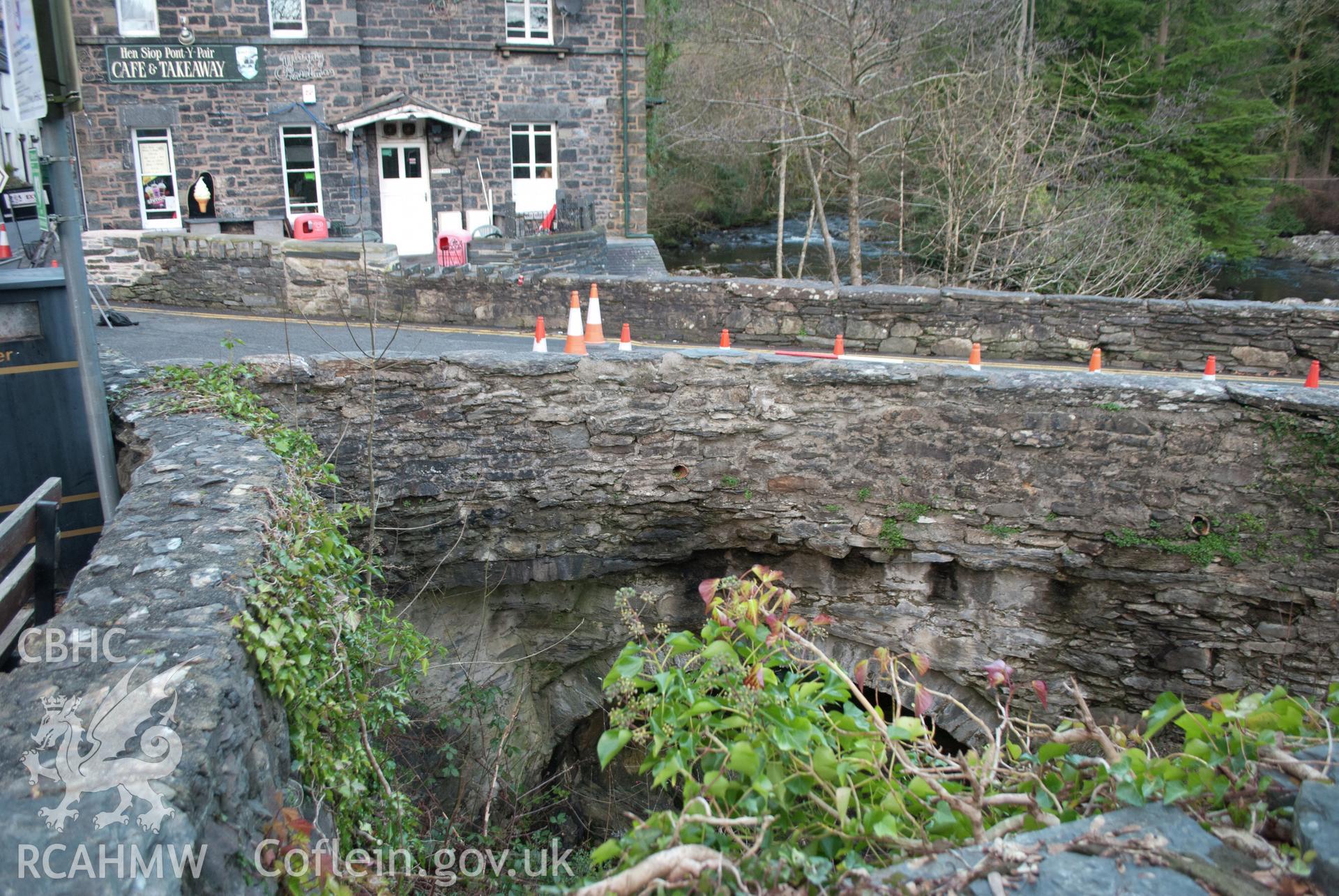 View from the south east of external (riverside) of the parapet walling in the southeast corner of the bridge. Digital photograph taken for Archaeological Watching Brief at Pont y Pair, Betws y Coed, 2019. Gwynedd Archaeological Trust Project ref G2587.