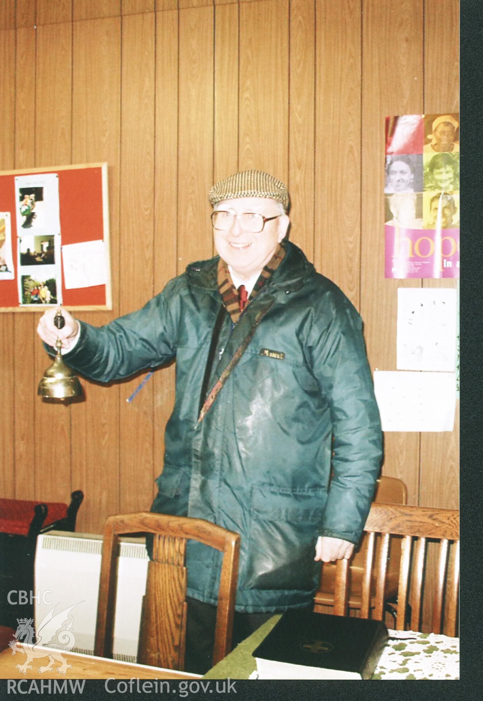Colour photograph of Cyril Philips with the Sunday School Bell, 2005. Donated to the RCAHMW by Cyril Philips as part of the Digital Dissent Project.