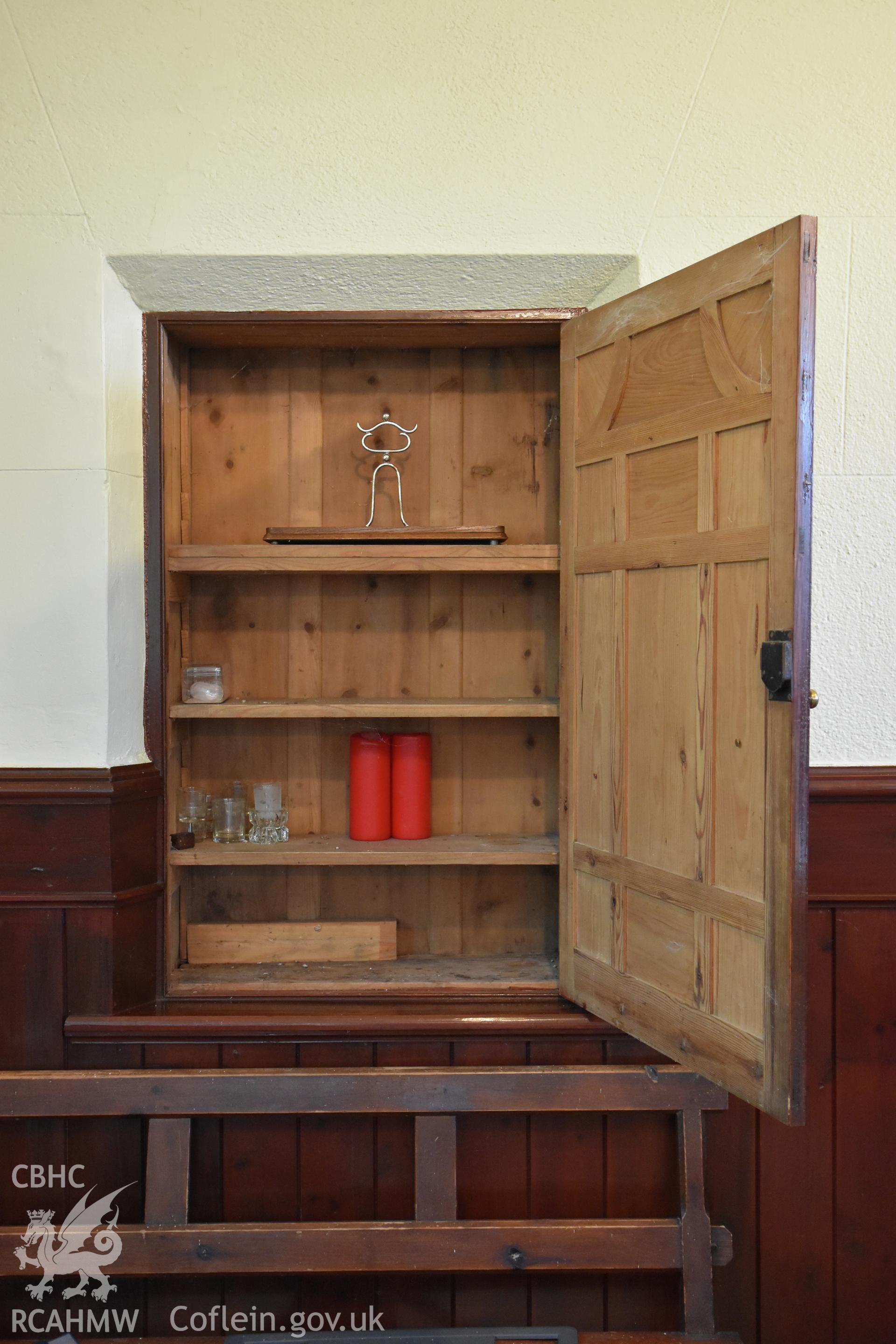 Detailed view of panelling, bench and open wooden cupboard at the rear Hyssington Primitive Methodist Chapel, Hyssington, Churchstoke. Photographic survey conducted by Sue Fielding on 7th December 2018.