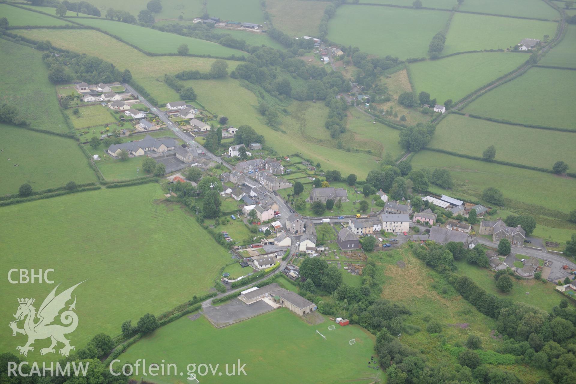 Llanboidy, Carmarthenshire, with St. Brynach's church and Trinity Welsh Independent chapel facing each other in the centre of the village. Oblique aerial photograph taken during the Royal Commission?s programme of archaeological aerial reconnaissance by Toby Driver on 1st August 2013.