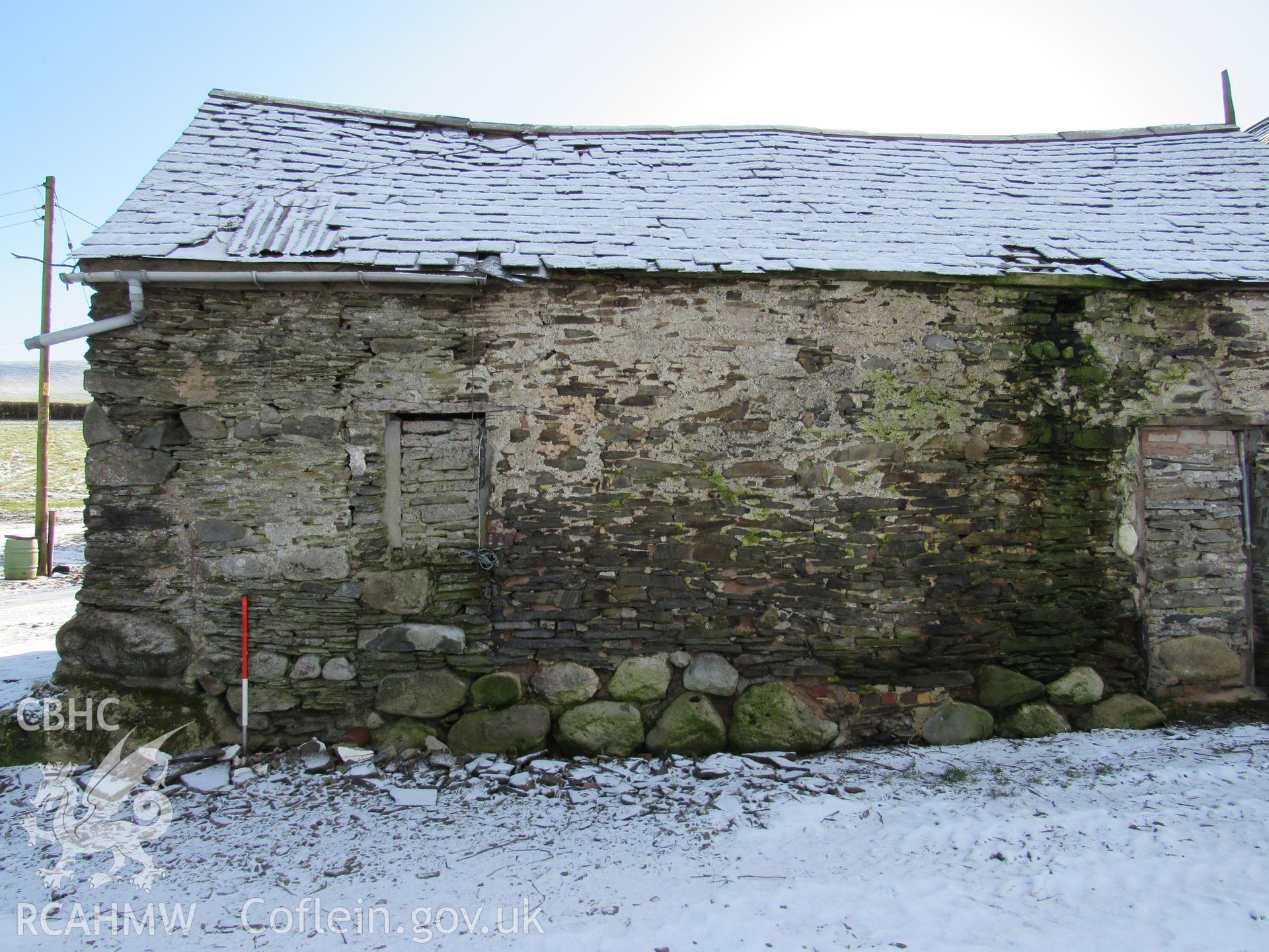 The barn north-west elevation, view south-east. 1m scale. Photographed as part of archaeological building recording conducted at Bryn Ysguboriau, Llanelidan, Denbighshire, carried out by Archaeology Wales, 2018. Project no. P2587.
