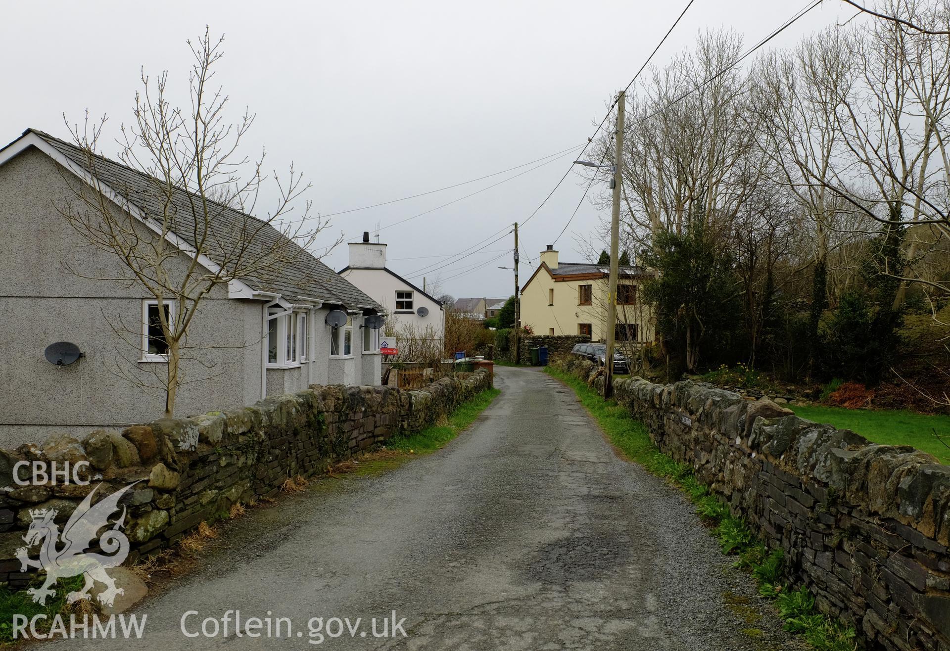 Colour photograph showing view looking south east at line of the Dinorwic Railway, Min afon and a roadside cottage, Clwt-y-bont, Deiniolen, produced by Richard Hayman 2nd February 2017