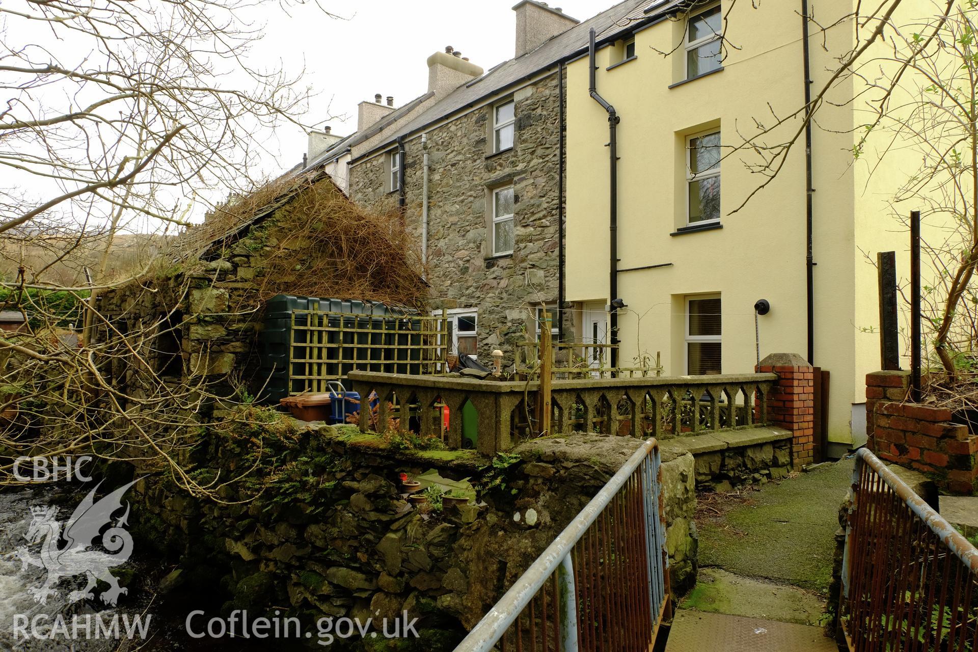 Colour photograph showing view looking south east at rear of Tai Glandwr houses, Min Afon (north side), Clwt-y-bont, Deiniolen, produced by Richard Hayman 7th March 2017