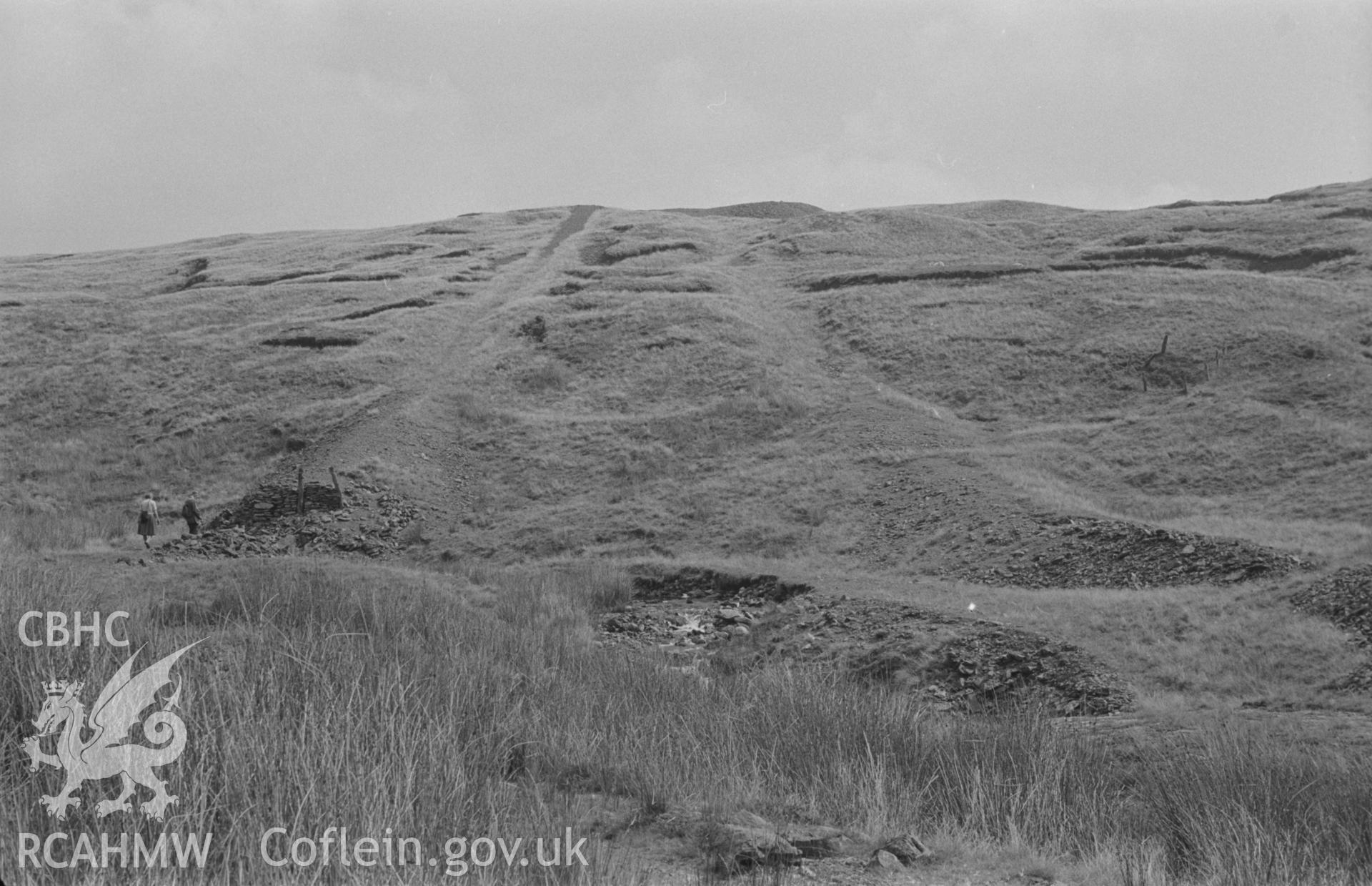 Digital copy of a black and white negative showing view looking up line of ballast of old tramway from Plynlimon mine up to shafts on slope to east. Photographed by Arthur O. Chater in August 1967. (Looking east from Grid Reference SN 796 858).