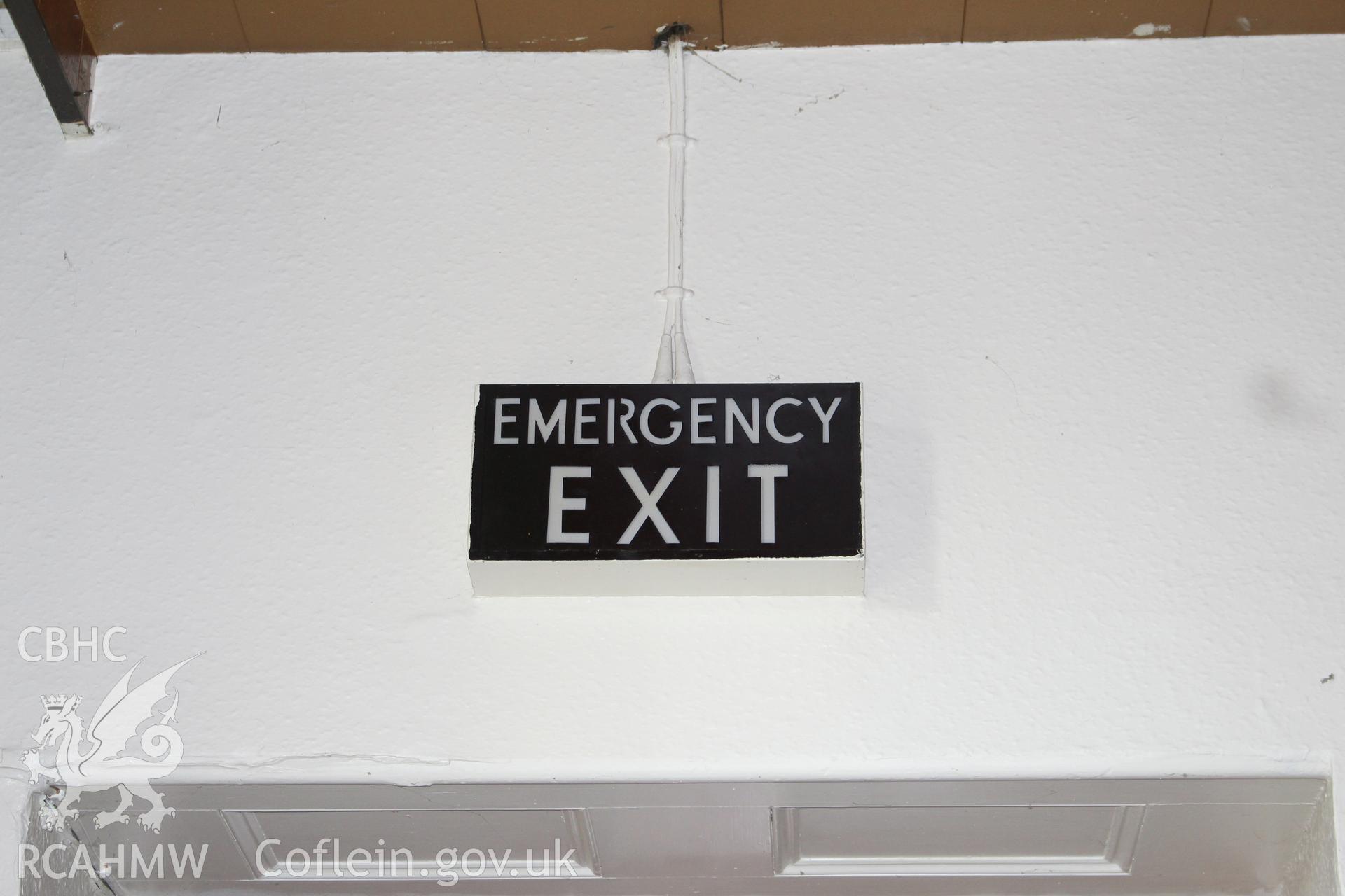 Detailed view of 'EMERGENCY EXIT' sign at the Railway Institute, Bangor. Photographed during survey conducted by Sue Fielding for the RCAHMW on 4th April 2016.