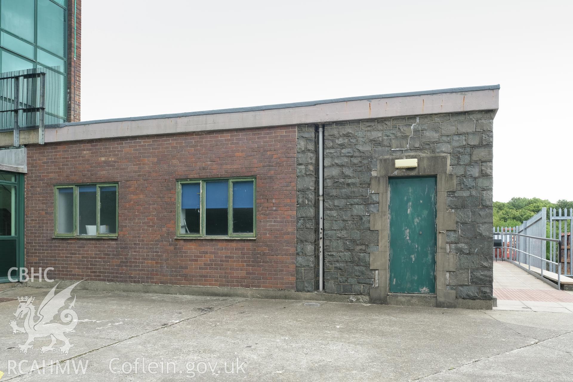 Digital colour photograph showing exterior view of single-storey part of building at Caernarfonshire Technical College, Ffriddoedd Road, Bangor. Photographed by Dilys Morgan, donated by Wyn Thomas of Grwp Llandrillo-Menai Further Education College, 2019.