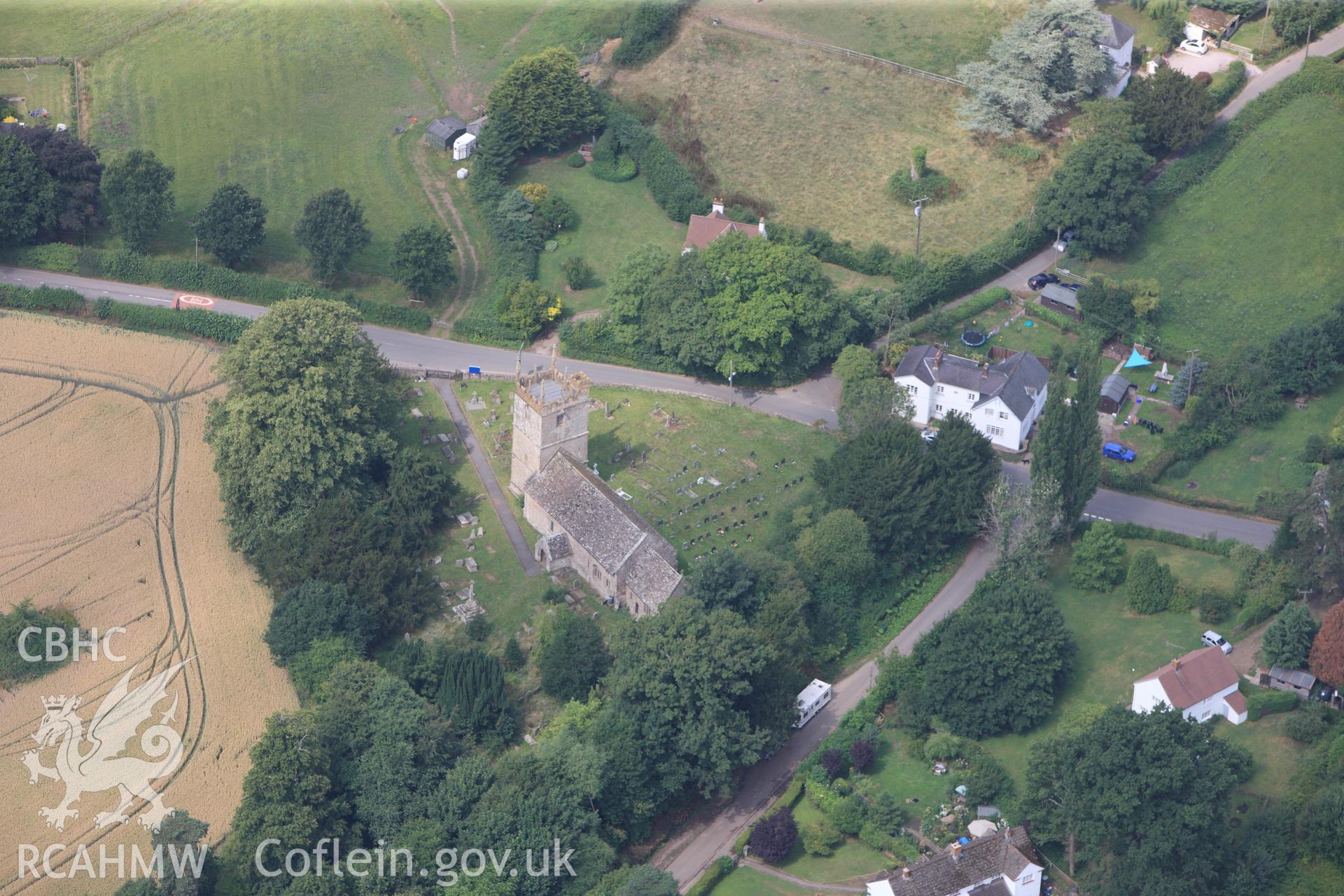 St. Teilo's church with the cross in the southern part of its churchyard, Llanarth, between Abergavenny and Monmouth. Oblique aerial photograph taken during the Royal Commission?s programme of archaeological aerial reconnaissance by Toby Driver on 1st August 2013.