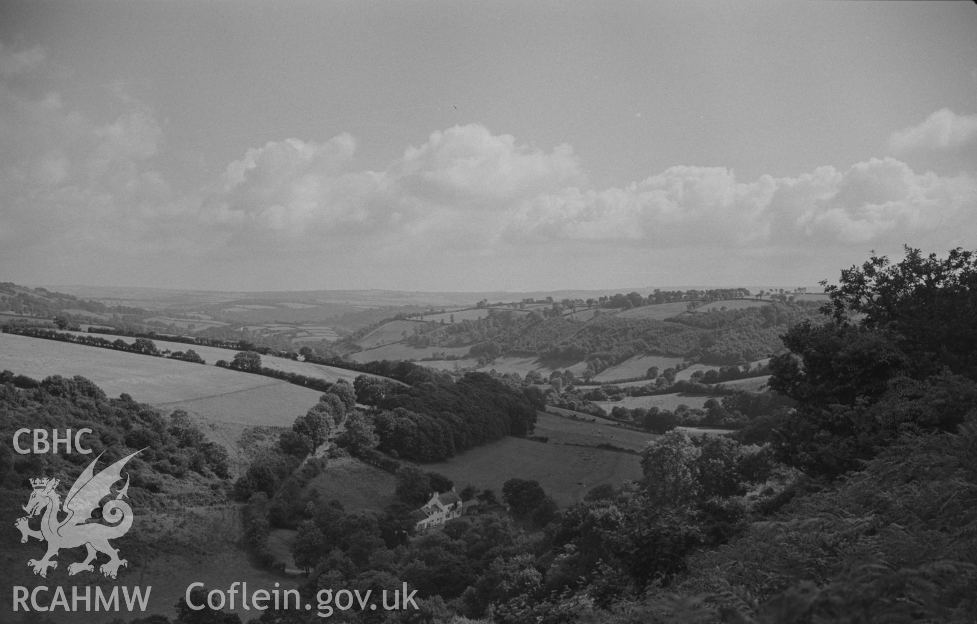 Digital copy of black and white negative showing view looking down to Dyffryn Llynod and, beyond, the Cerdin valley from near the site of St. Ffraid's church. Photographed by Arthur O. Chater on 19th August 1967, looking south south east from SN 405 459.