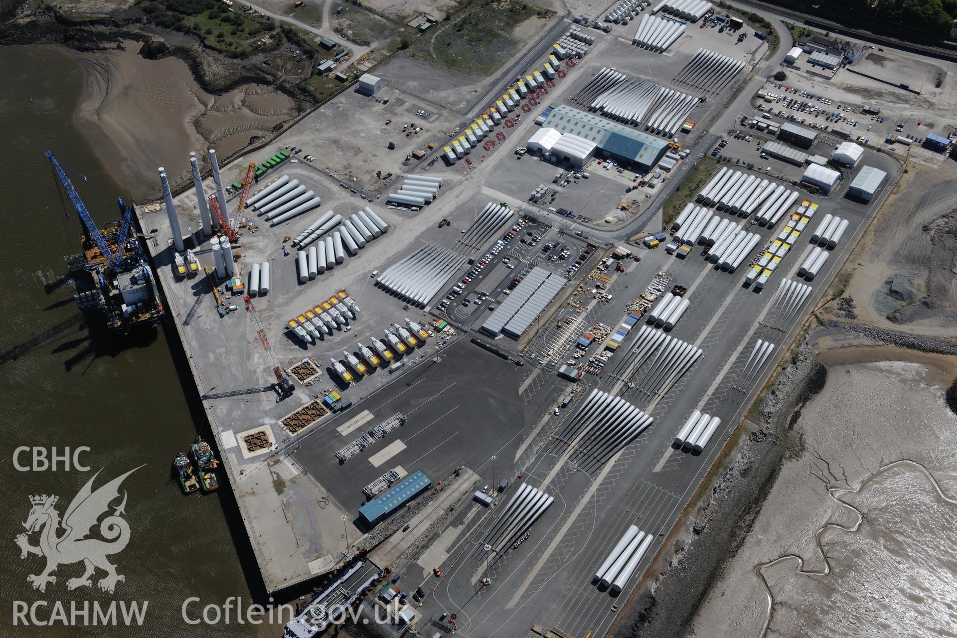 Mostyn Quay in the port of Mostyn, with windfarm parts. Oblique aerial photograph taken during the Royal Commission?s programme of archaeological aerial reconnaissance by Toby Driver on 22nd May 2013.