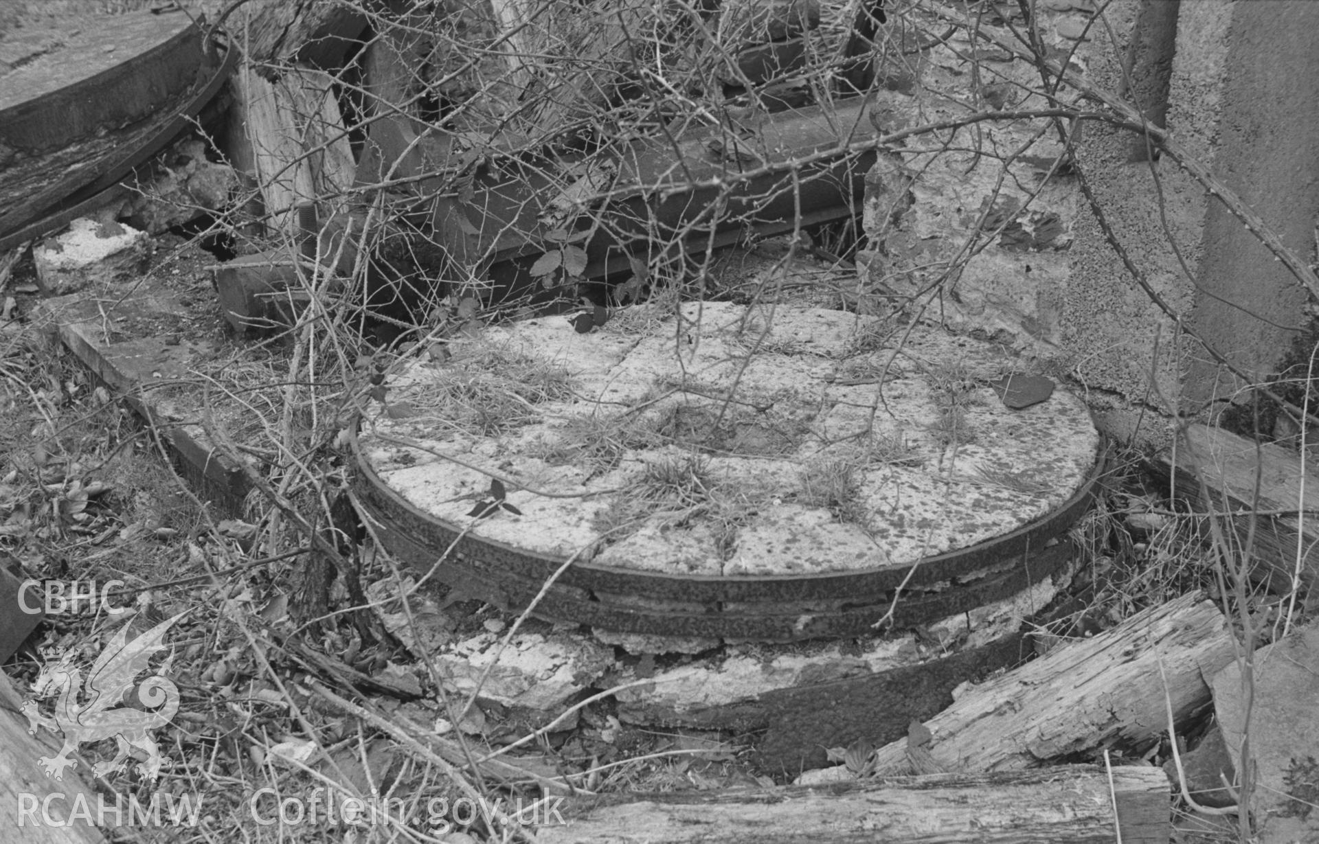 Digital copy of a black and white negative showing millstone at Felin Llanio ruined mill, north west of Llanddewi Brefi. Photographed in March 1964 by Arthur O. Chater from Grid Reference SN 6464 5644.