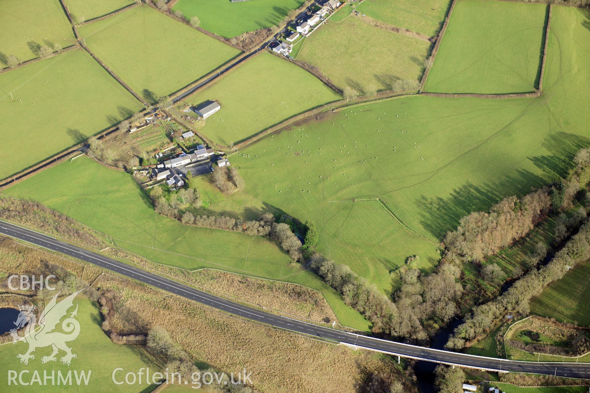 Views of Gilfachwen-Uchaf defended enclosure and earthworks, and Gilfachwen Mansion. Oblique aerial photograph taken during the Royal Commission's programme of archaeological aerial reconnaissance by Toby Driver on 6th January 2015.