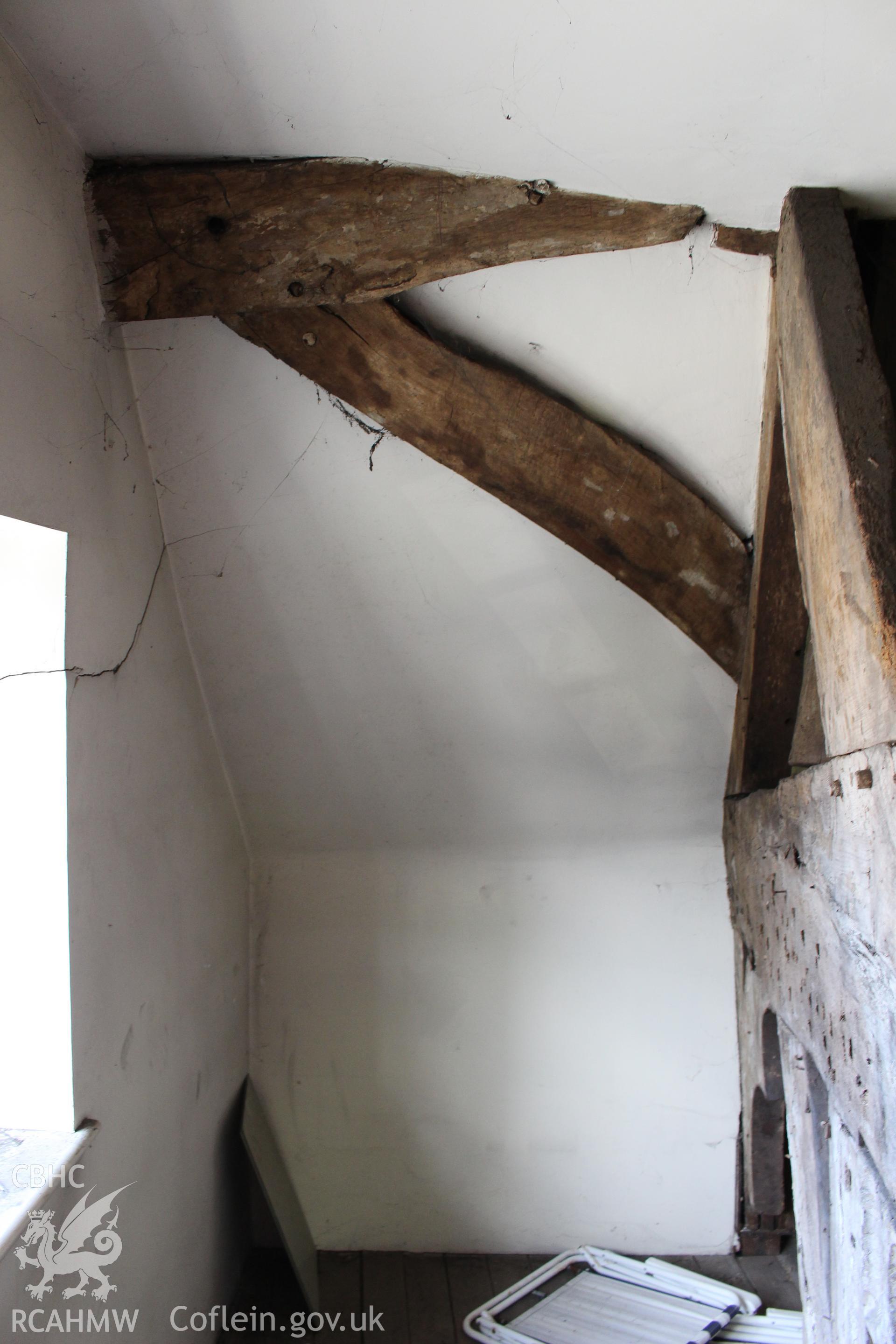 Colour photograph showing detail of timber frame on the attic level at 5-7 Mwrog Street, Ruthin. Photographed during survey conducted by Geoff Ward on 14th May 2014.