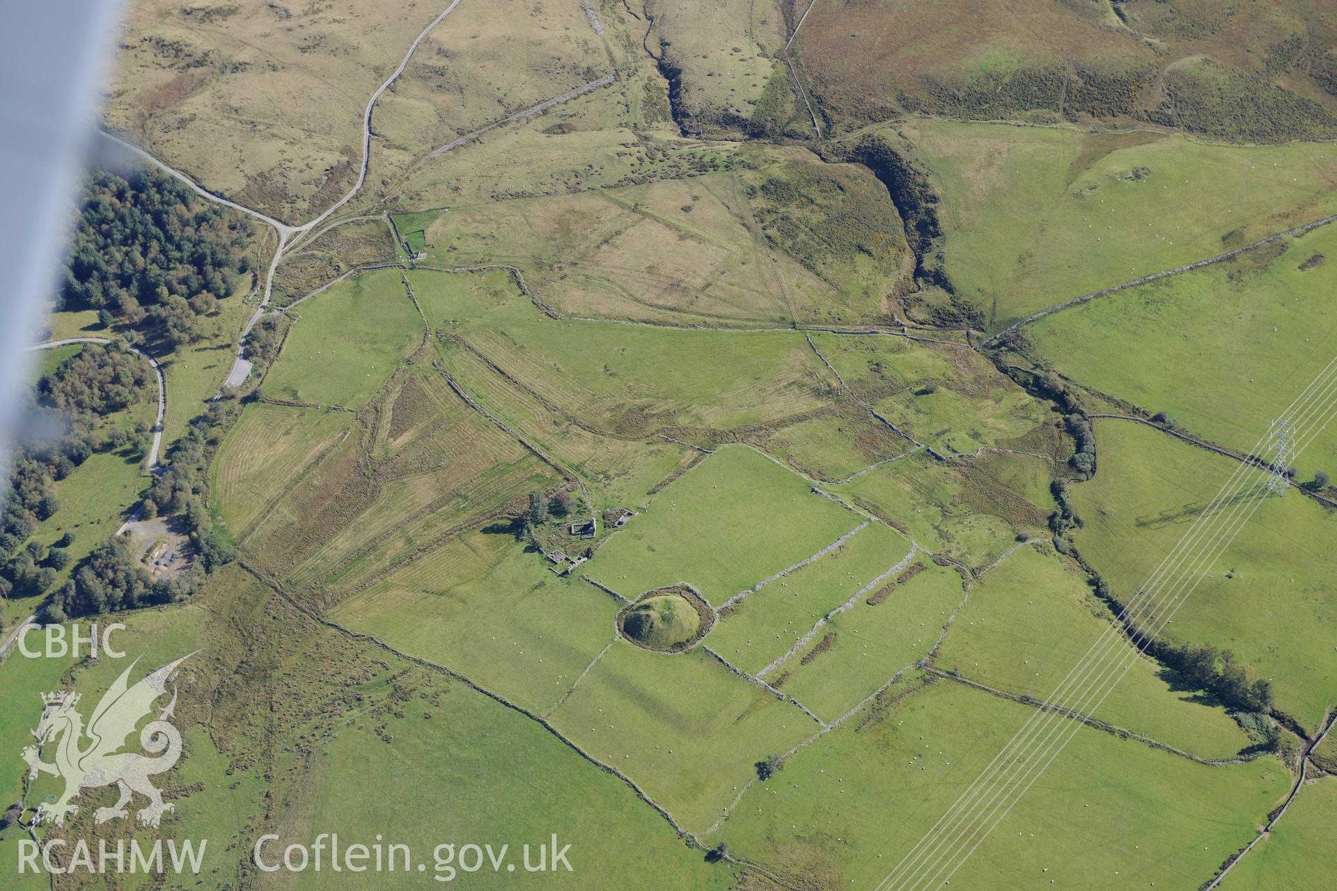 Tomen y Mur castell, Tomen y Mur roman fort and Tomen y Mur farm. Oblique aerial photograph taken during the Royal Commission's programme of archaeological aerial reconnaissance by Toby Driver on 2nd October 2015.