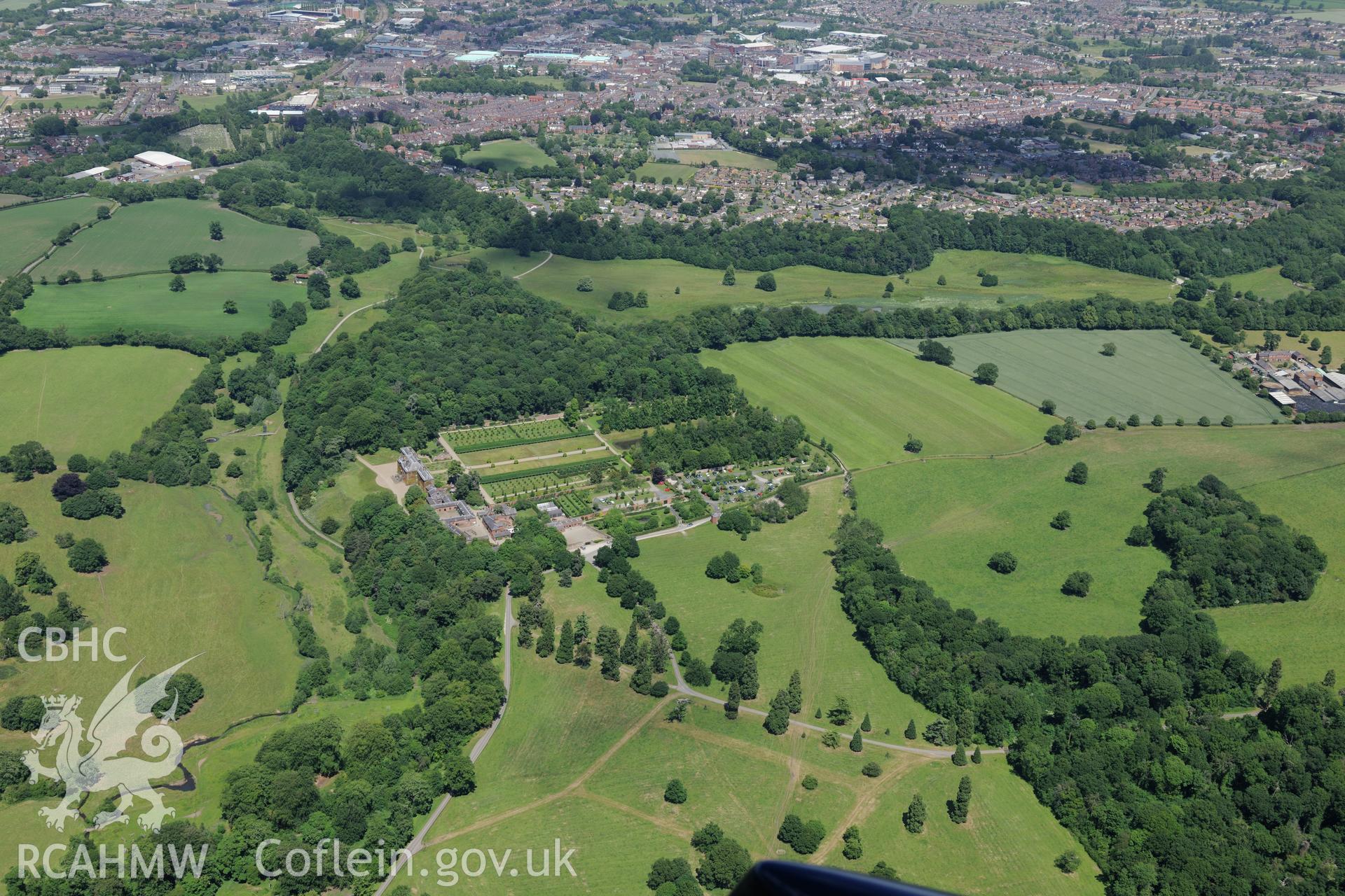 Erddig Hall and its gardens, with a deserted settlement in its park and the town of Wrexham beyond. Oblique aerial photograph taken during the Royal Commission's programme of archaeological aerial reconnaissance by Toby Driver on 30th June 2015.