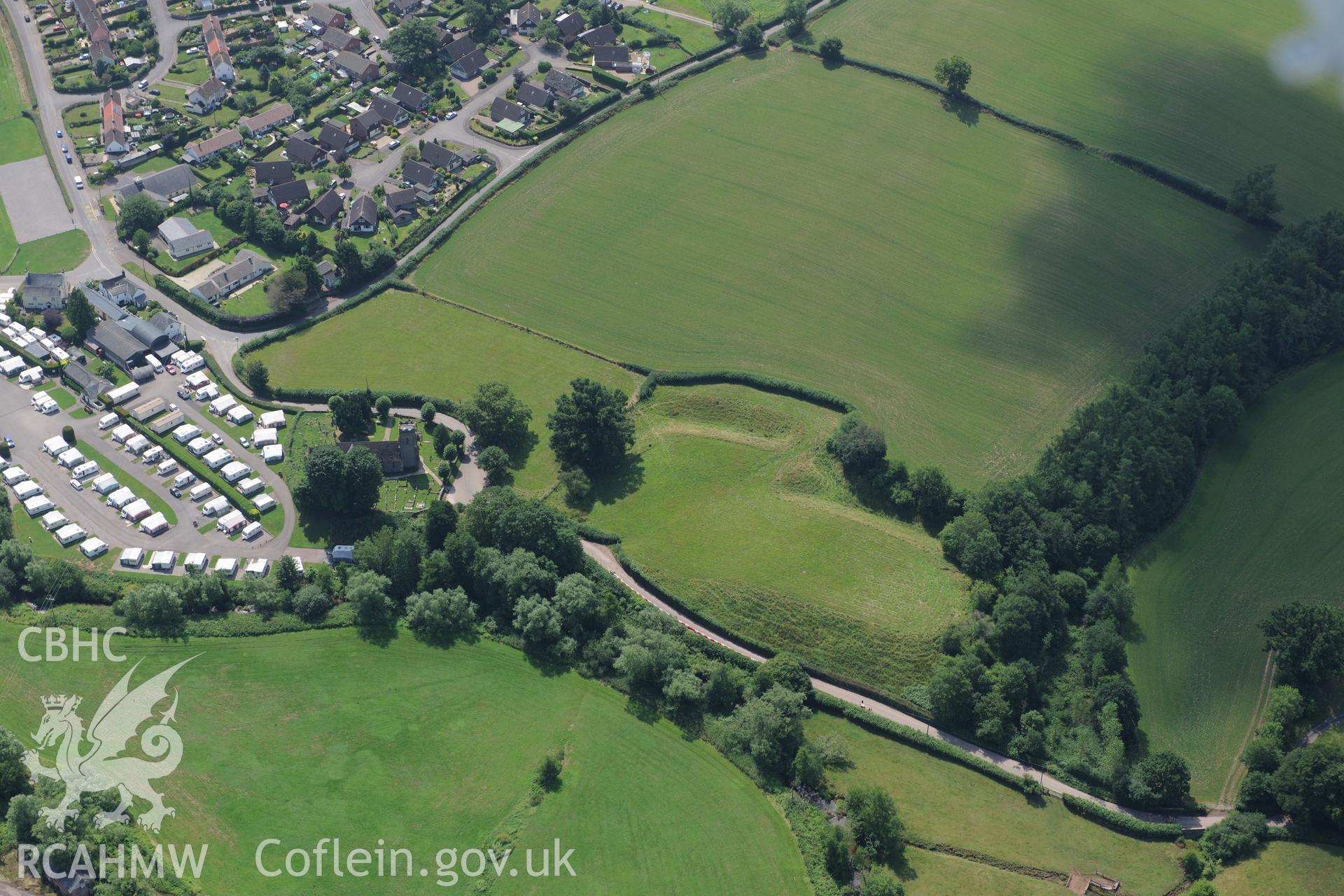 Dingestow village, with St. Dingat's Church and Dingestow Castle in the centre of the photograph. Oblique aerial photograph taken during the Royal Commission?s programme of archaeological aerial reconnaissance by Toby Driver on 1st August 2013.