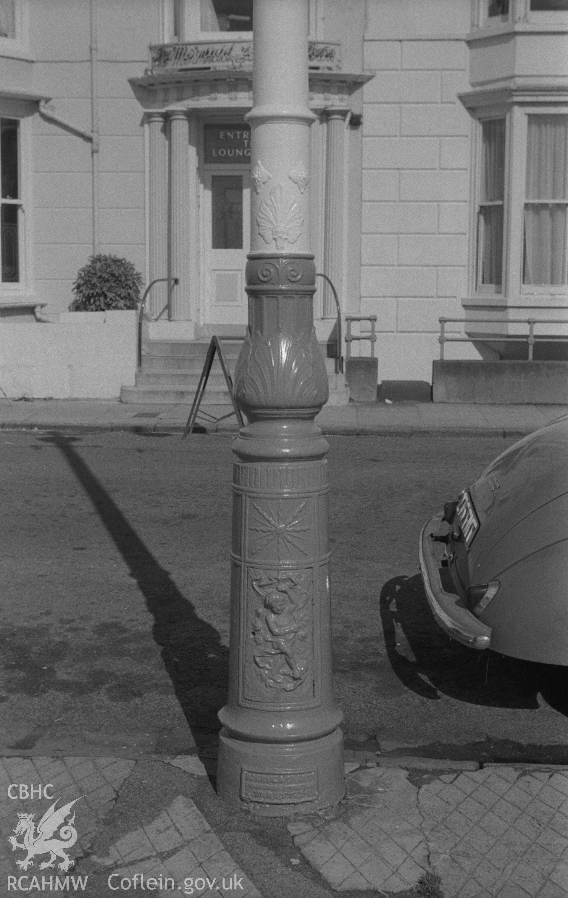 Digital copy of a black and white negative showing lamp post on Aberystwyth promenade near public shelter (opposite Marine hotel). Photographed by Arthur O. Chater in August 1967 looking east from Grid Reference SN 583 821.