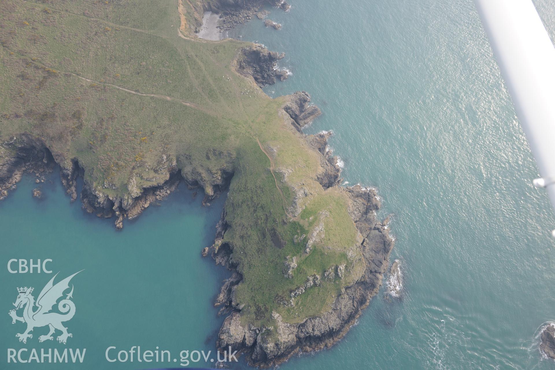 Royal Commission aerial photograph of Wooltack point promontory enclosure taken on 27th March 2017. Baseline aerial reconnaissance survey for the CHERISH Project. ? Crown: CHERISH PROJECT 2017. Produced with EU funds through the Ireland Wales Co-operation Programme 2014-2020. All material made freely available through the Open Government Licence.
