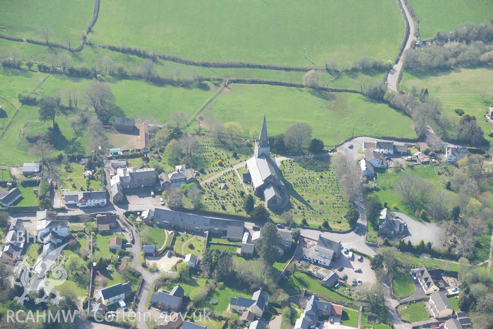 Trellech village and medieval borough including St. Nicholas' Church, Churchyard Cross and Vicarage; medieval houses sites west of the Church; the Lion Inn; old village school; Court Farm; Tump Terret and Trellech motte. Oblique aerial photograph taken during the Royal Commission's programme of archaeological aerial reconnaissance by Toby Driver on 21st April 2015.