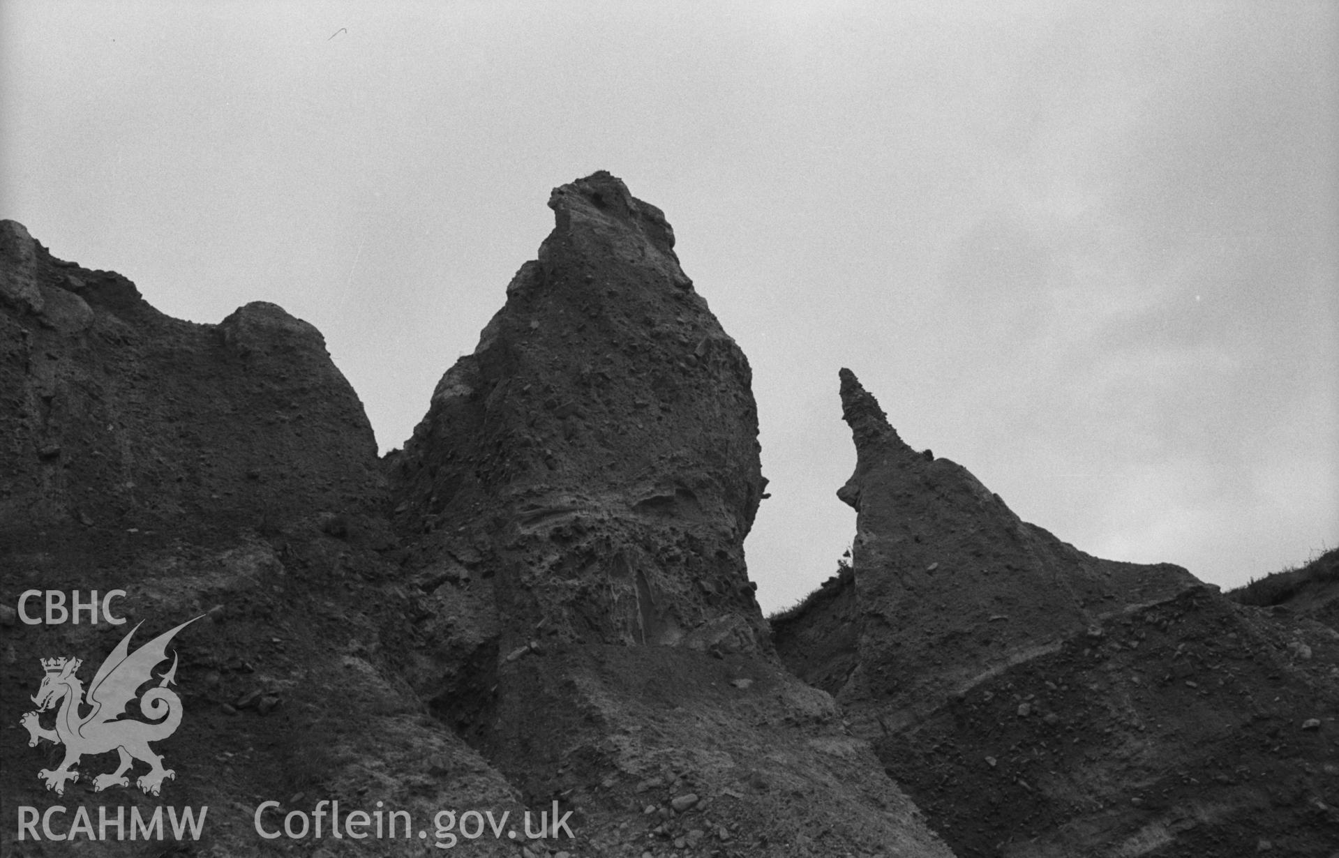 Black and White photograph showing weathering of cliffs 200m north east of the mouth of the Afon Gwinton at Gilfach yr Halen beach. Photographed by Arthur Chater in August 1962 from Grid Reference SN 437 615, looking south.