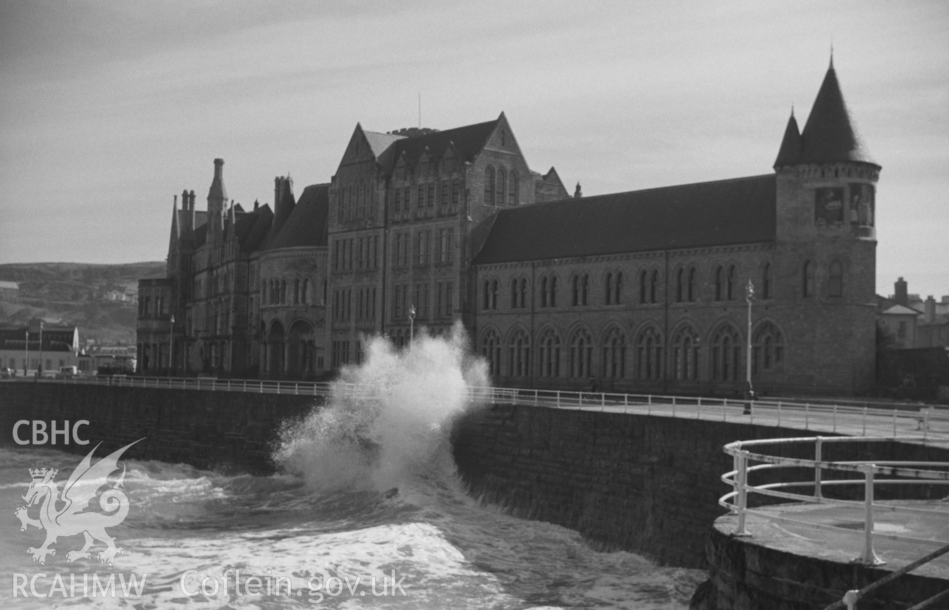 Black and White photograph showing Old College, Aberystwyth during storm. Photographed by Arthur Chater in April 1962, from the promenade (Grid Reference: SN 5794 8162, looking north east).