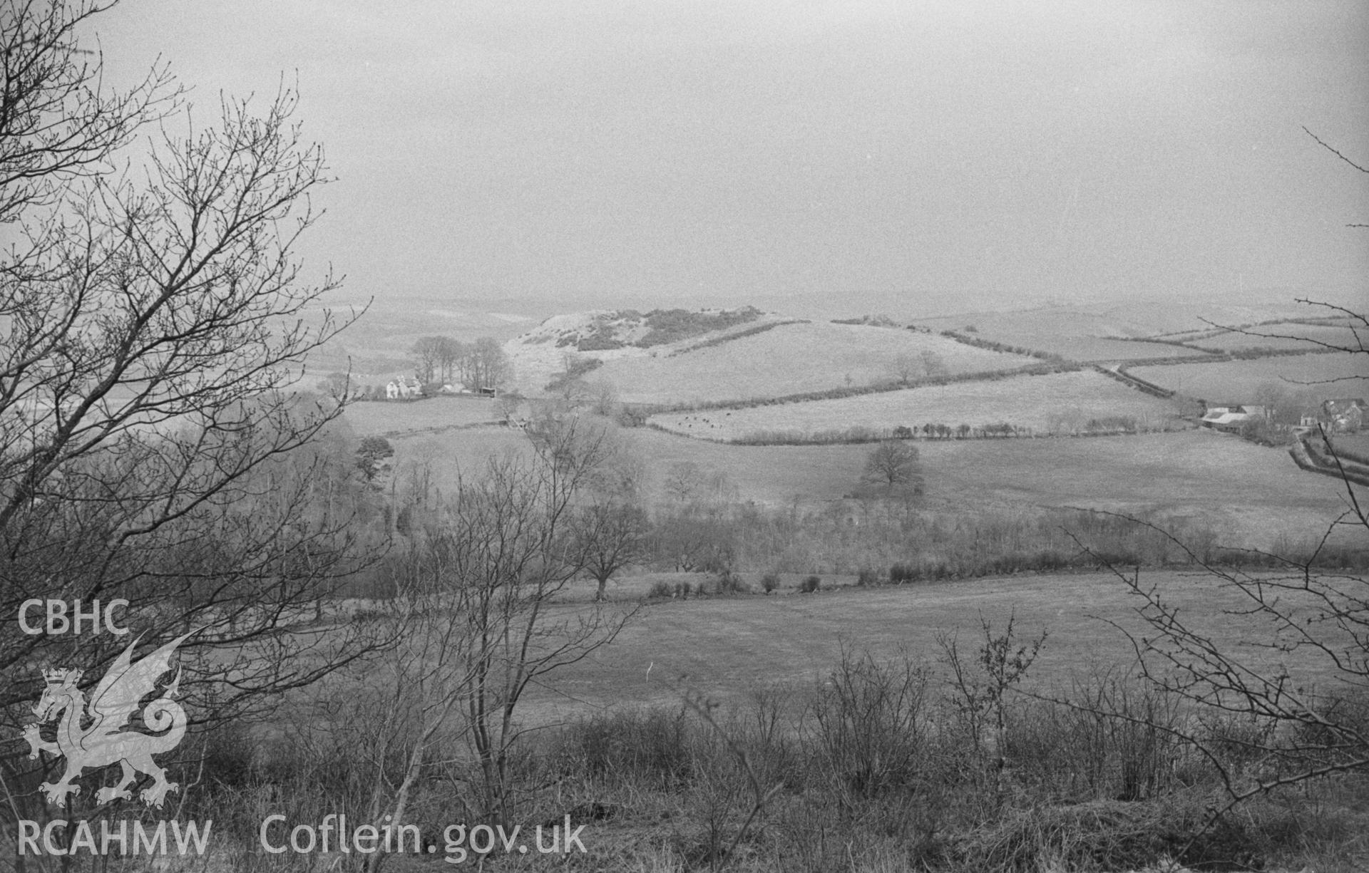 Black and White photograph showing Pen-y-Castell, Llanilar, from the lane to Coed-Ll?s. Photographed by Arthur Chater in April 1962 from Grid Reference SN 623 741, looking north east.