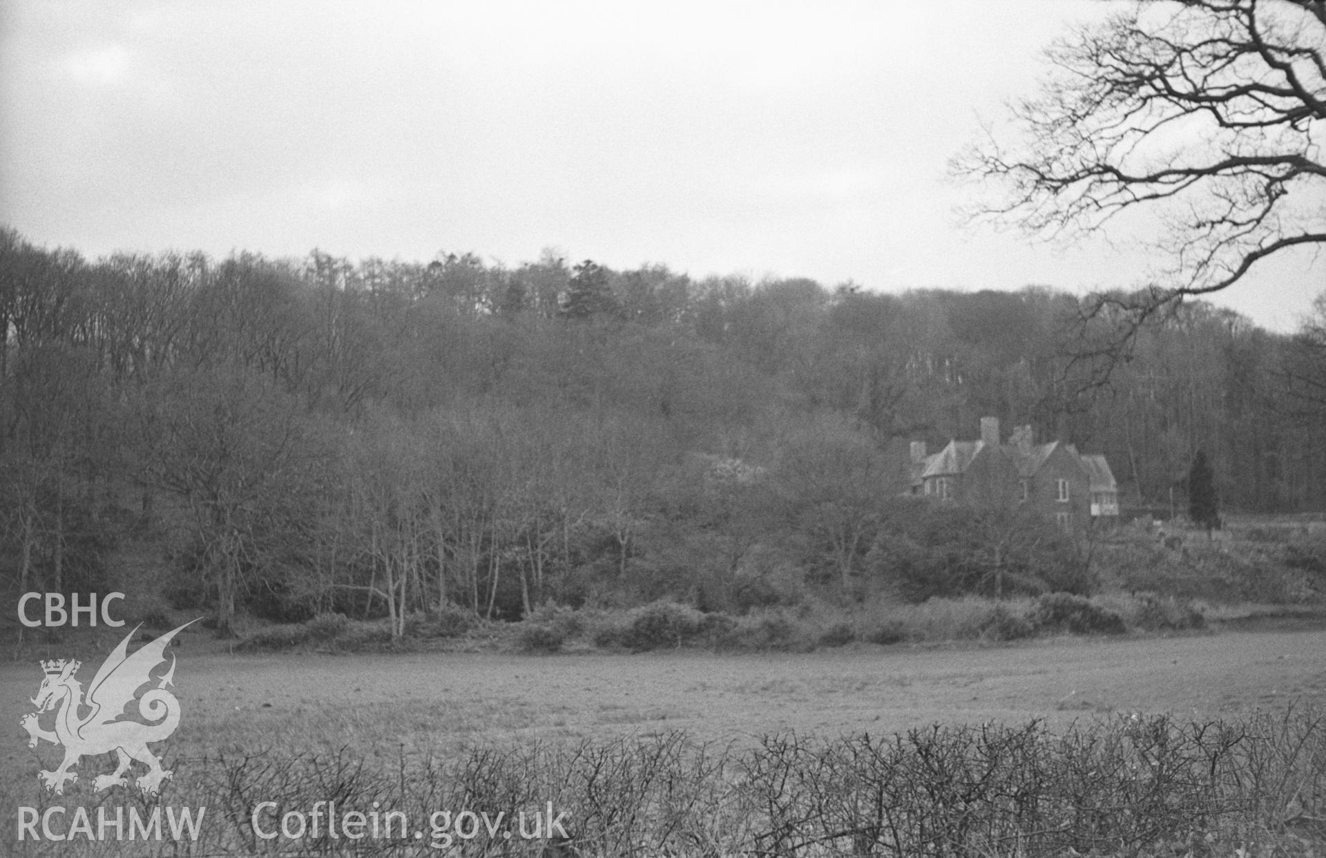 Black and White photograph showing distant view of  Plas Llidiardau, Llanilar, from the road; heronry in trees on skyline to the left. Photographed by Arthur Chater in April 1962 from Grid Reference SN 641 745, looking south west.