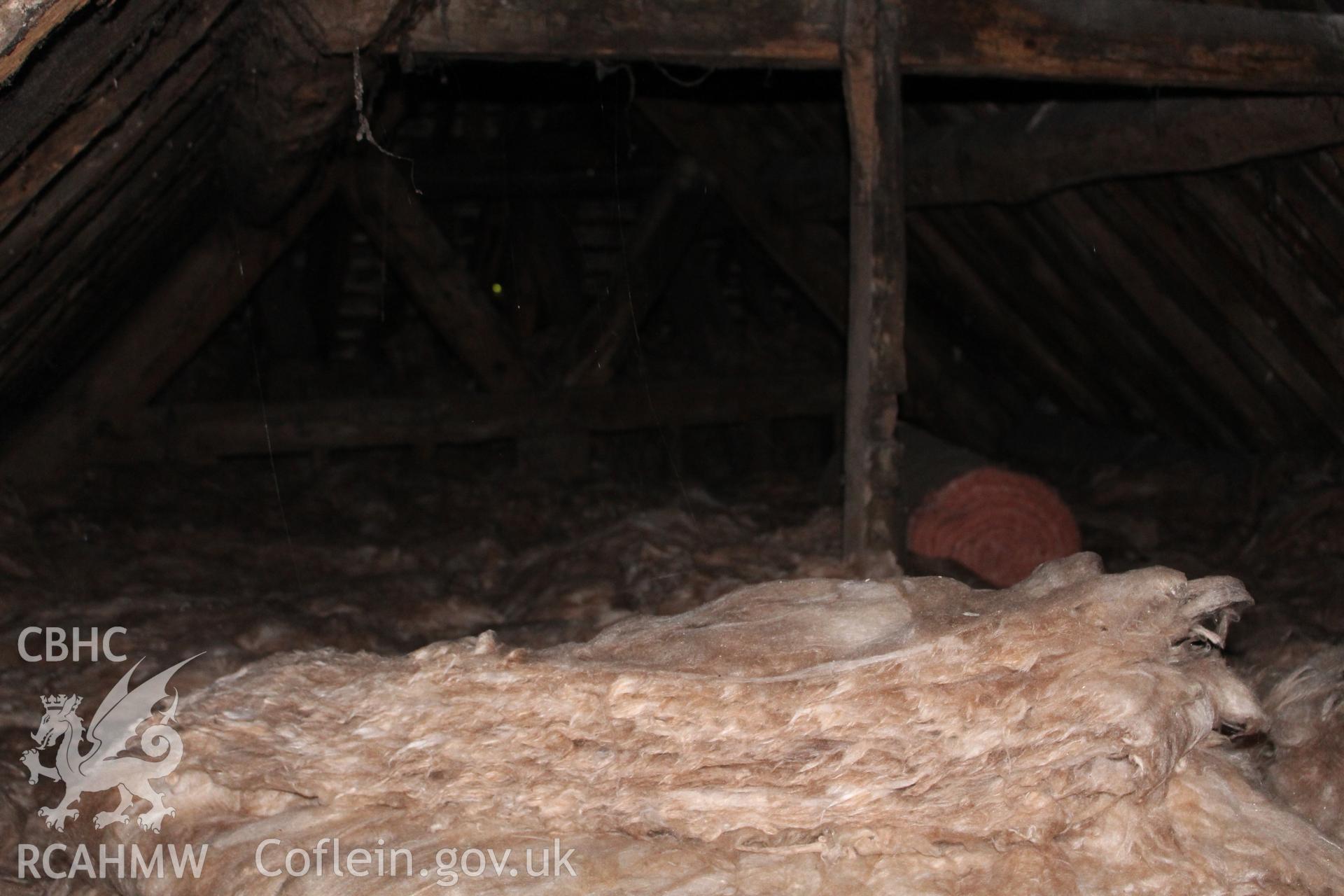 Colour photograph showing detail of insulating wool and timber roof frame at 5-7 Mwrog Street, Ruthin. Photographed during survey conducted by Geoff Ward on 14th May 2014.