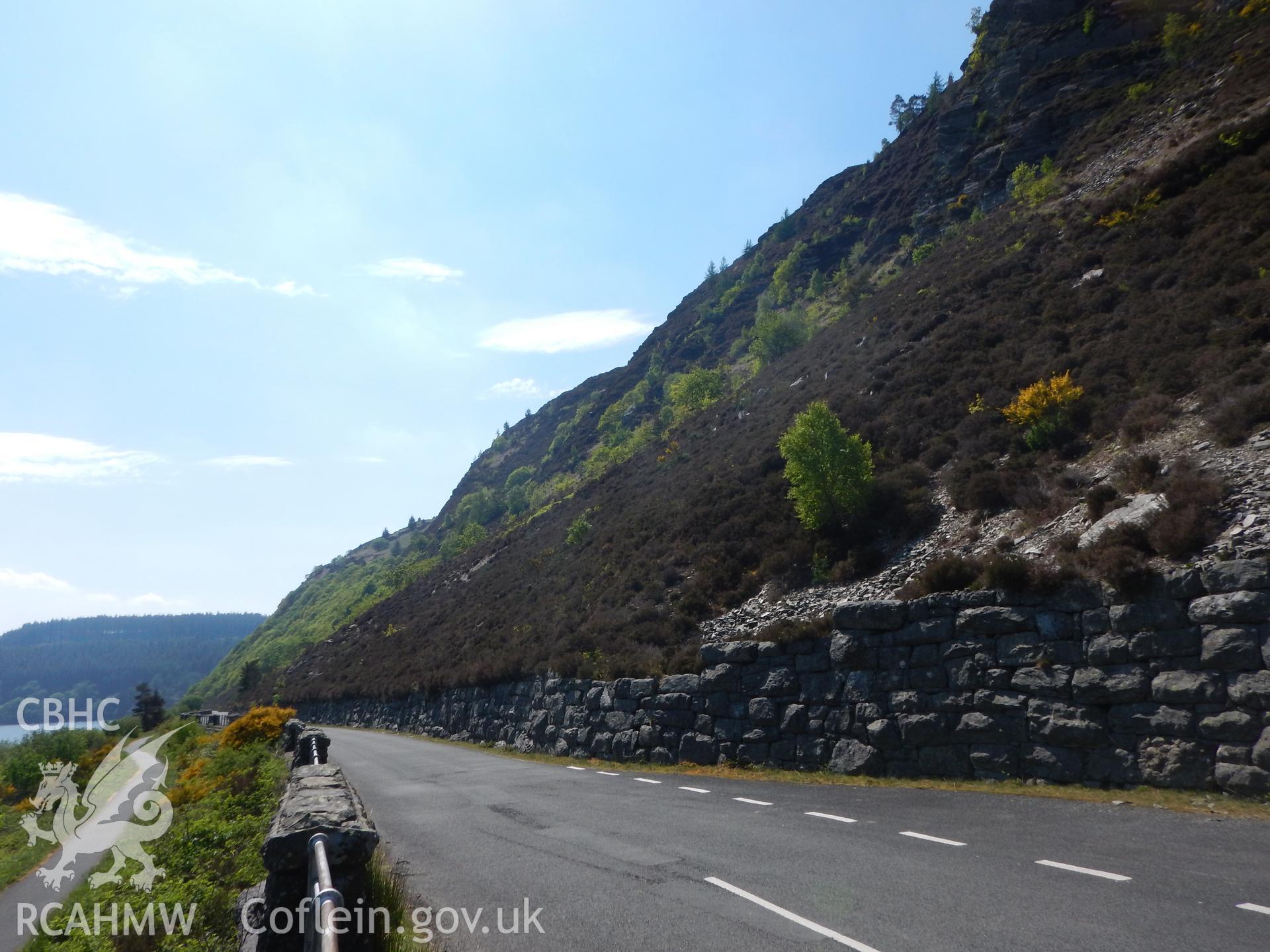View along proposed cable route on north-west bank of Caban Coch reservoir, showing stone revetments on the road. Photographed for Archaeological Desk Based Assessment of Afon Claerwen, Elan Valley, Rhayader. Assessment by Archaeology Wales in 2018.