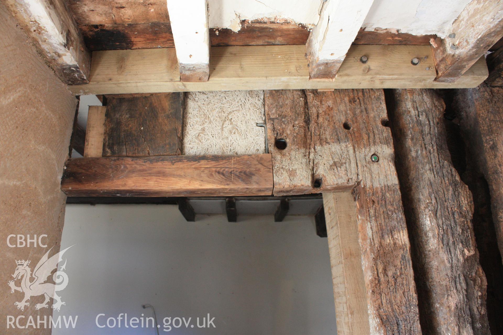 Colour photograph showing detail of cut back post and stud to form later doorway from hall into crosswing at Porth-y-Dwr, 67 Clwyd Street, Ruthin. Photographed during survey conducted by Geoff Ward on 10th June 2013.