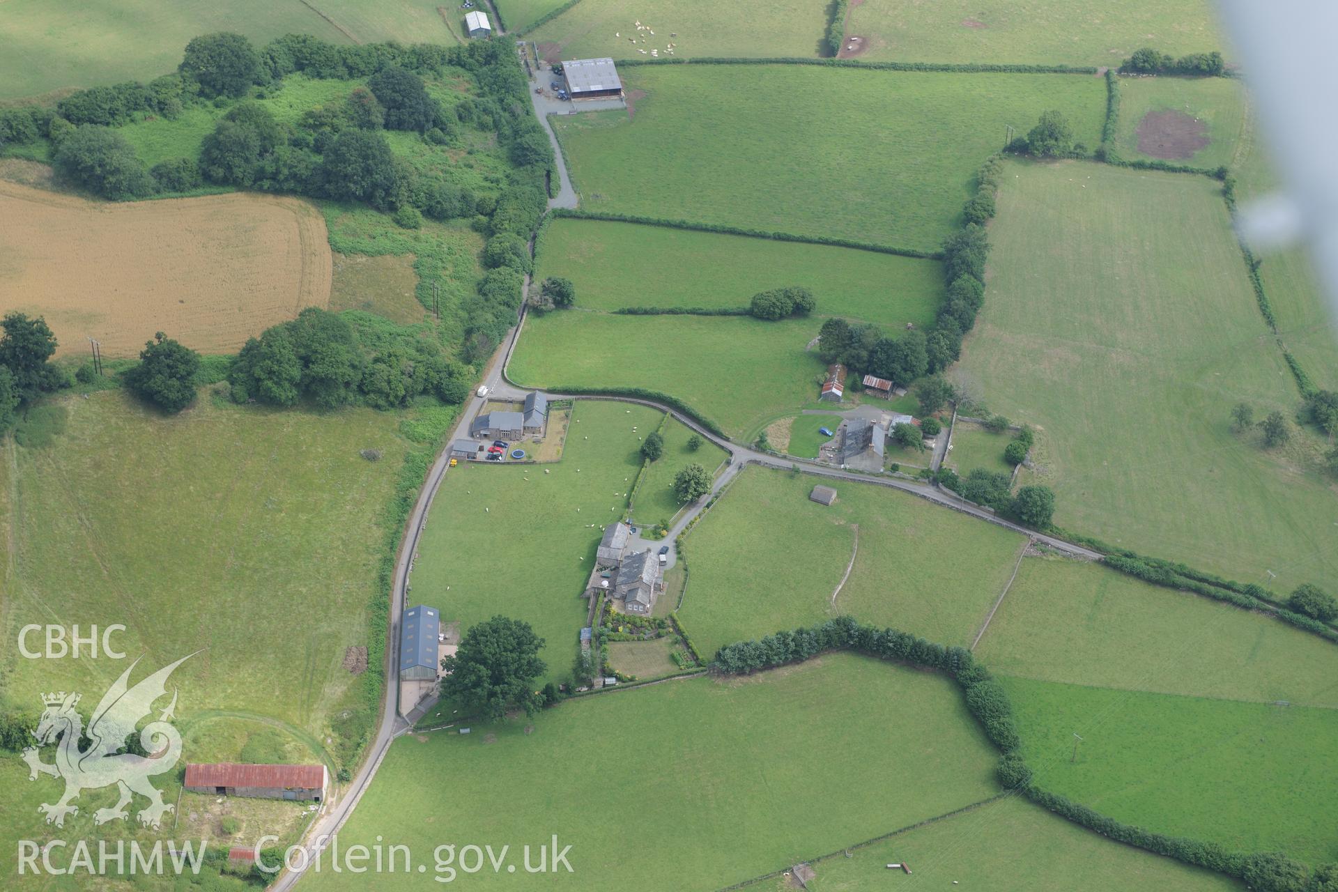 Pen-y-Gaer Roman fort, with the modern Pen-y-Gaer farm (on the right) and Greenhill farmstead (on the left). Oblique aerial photograph taken during the Royal Commission?s programme of archaeological aerial reconnaissance by Toby Driver on 1st August 2013.