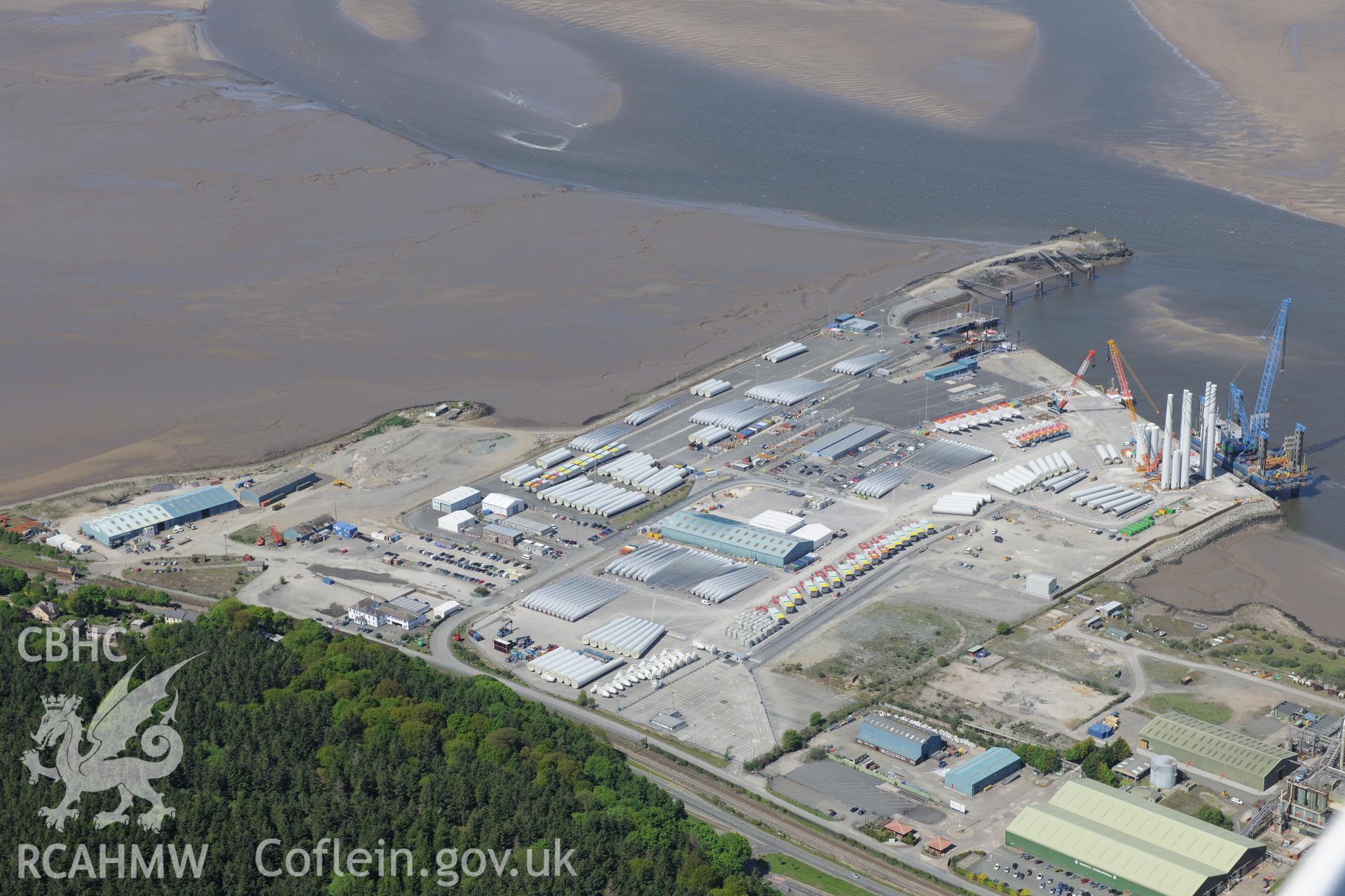 Mostyn Quay in the port of Mostyn, with windfarm parts. Oblique aerial photograph taken during the Royal Commission?s programme of archaeological aerial reconnaissance by Toby Driver on 22nd May 2013.