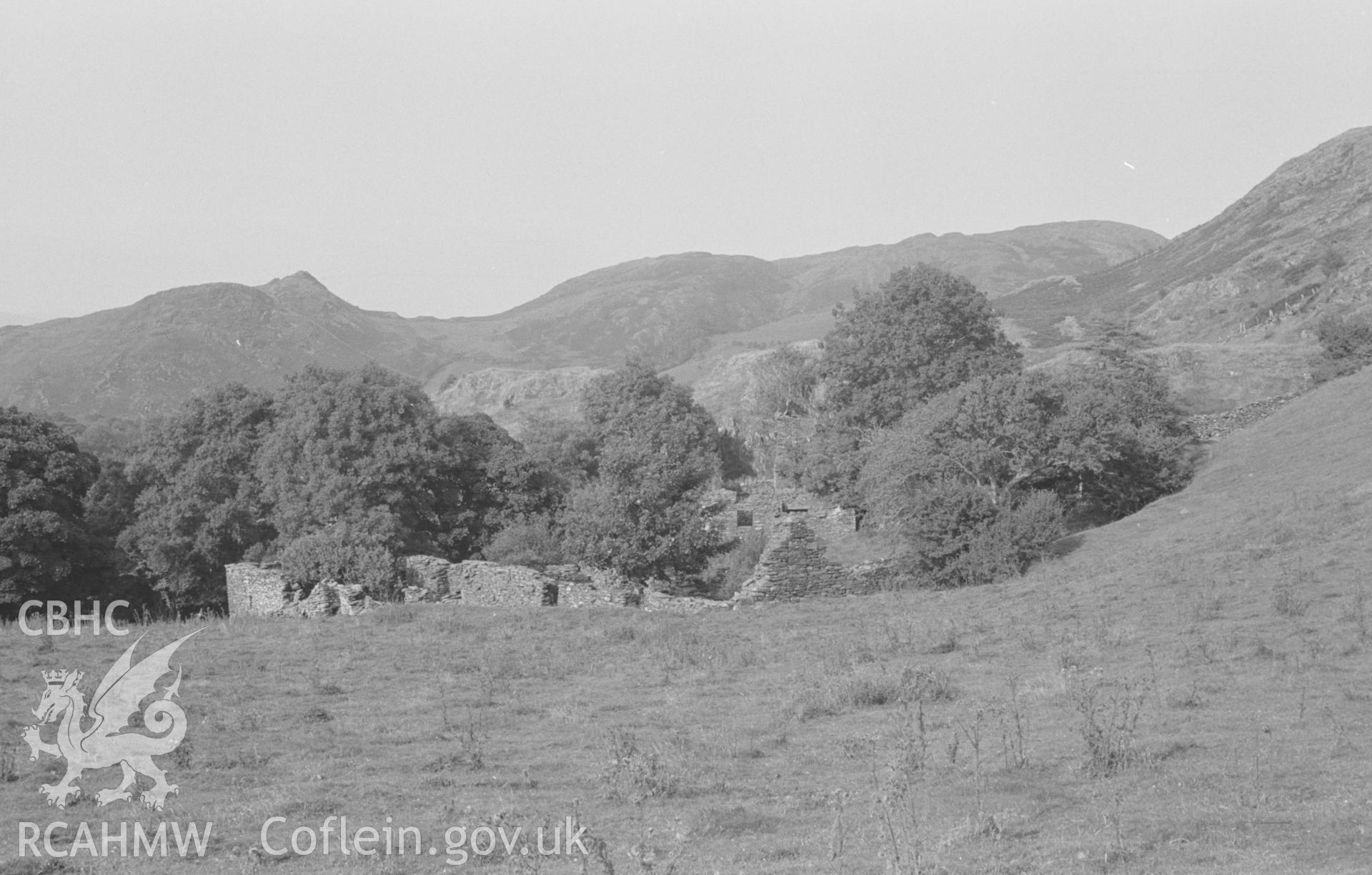Digital copy of a black and white negative showing the ruins of Neuaddlwyn, Foel Fawr on skyline at left, near Eglwysfach, Machynlleth. Photographed by Arthur O. Chater in August 1966 from Grid Reference SN 686 937, looking north east.