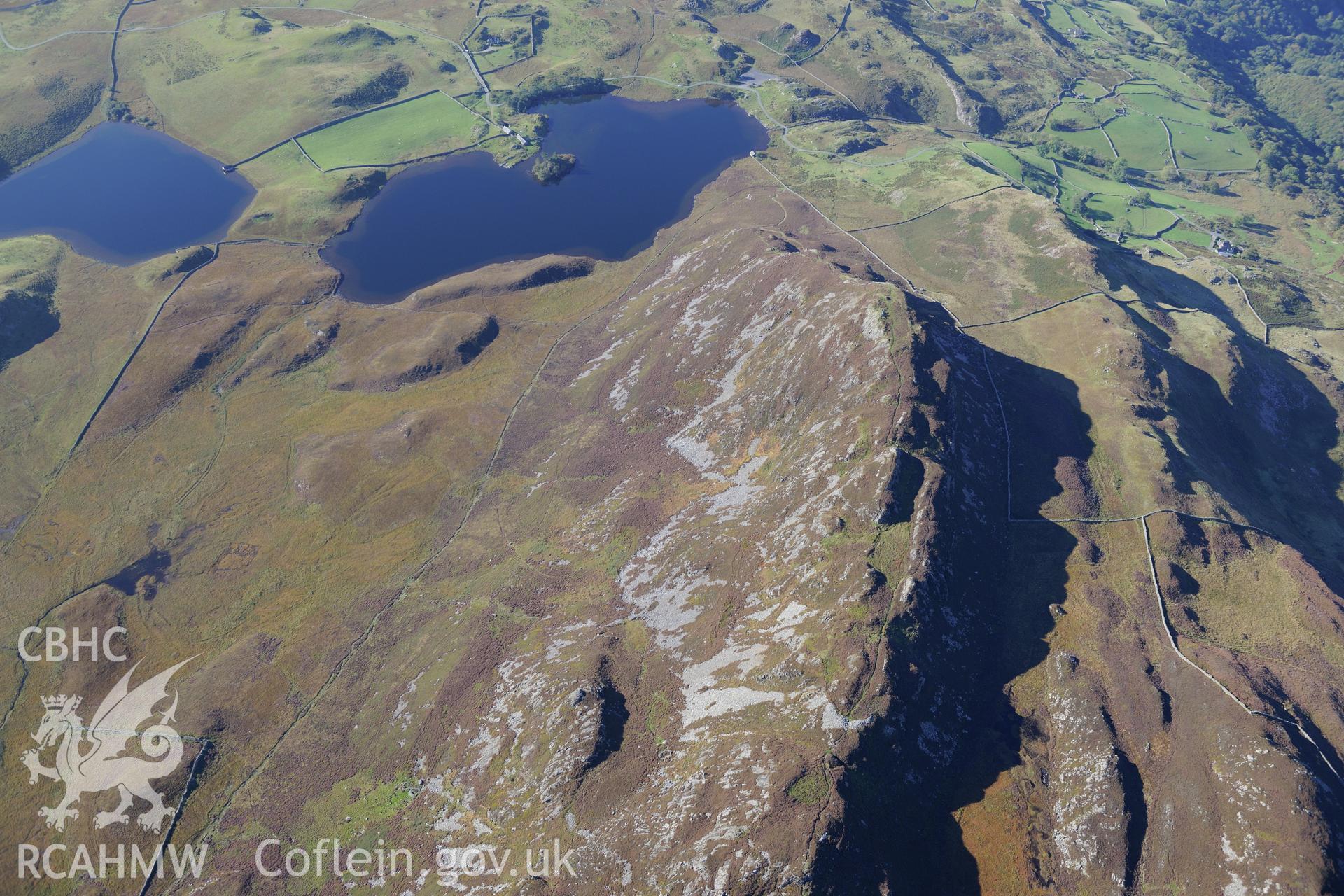 Pared y Cefnhir hillfort and Llynnau Cregennen, about halfway between Dolgellau and Fairbourne. Oblique aerial photograph taken during the Royal Commission's programme of archaeological aerial reconnaissance by Toby Driver on 2nd October 2015.