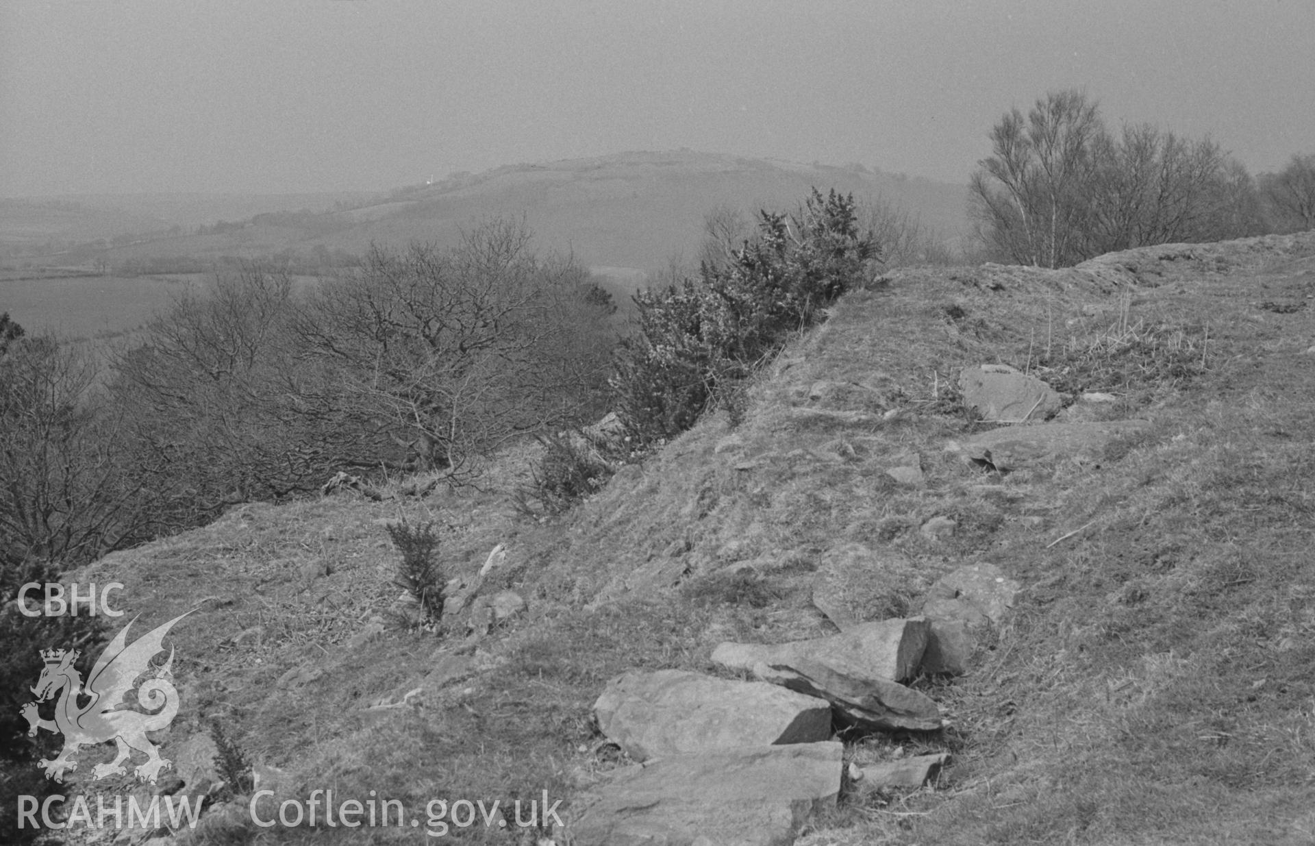 Digital copy of black & white negative showing view across the north west ramparts of Craig Gwytheyrn and over the Teifi valley to Pencoed-y-Foel camp. Photograph by Arthur O. Chater, 12 April 1967, looking north north west from Grid Reference SN 433 403.