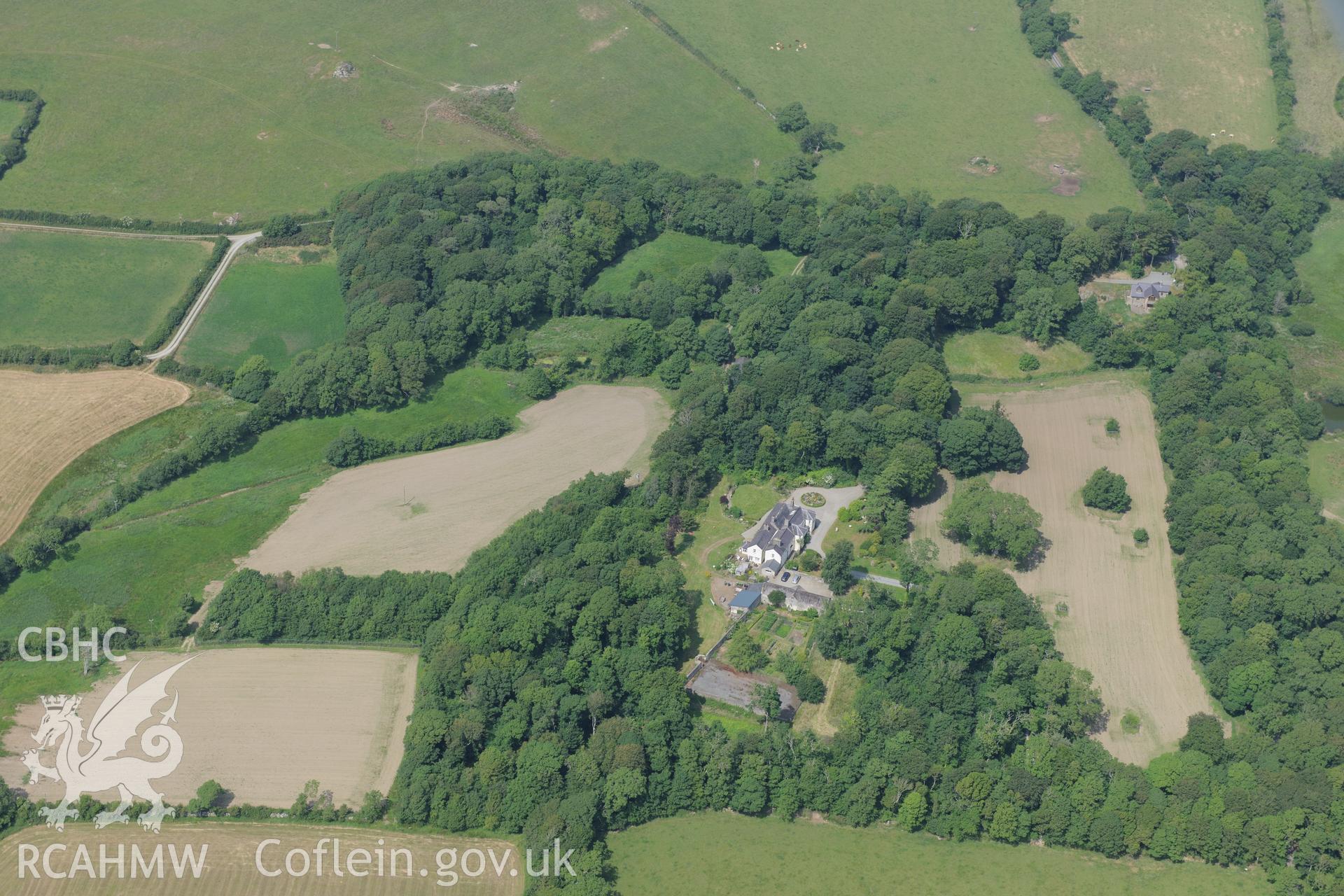 The lodge and garden at Llynnon Hall, Llanddeusant, north east of Holyhead. Oblique aerial photograph taken during the Royal Commission?s programme of archaeological aerial reconnaissance by Toby Driver on 12th July 2013.
