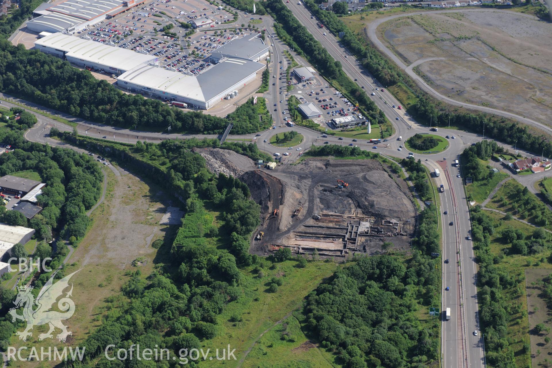 Site of former Rotax factory, Cyfarthfa Retail Park, and Cyfarthfa Ironworks including the remains of its blast furnaces, under excavation by Glamorgan-Gwent Archaeological Trust. Oblique aerial photograph taken during the Royal Commission?s programme of