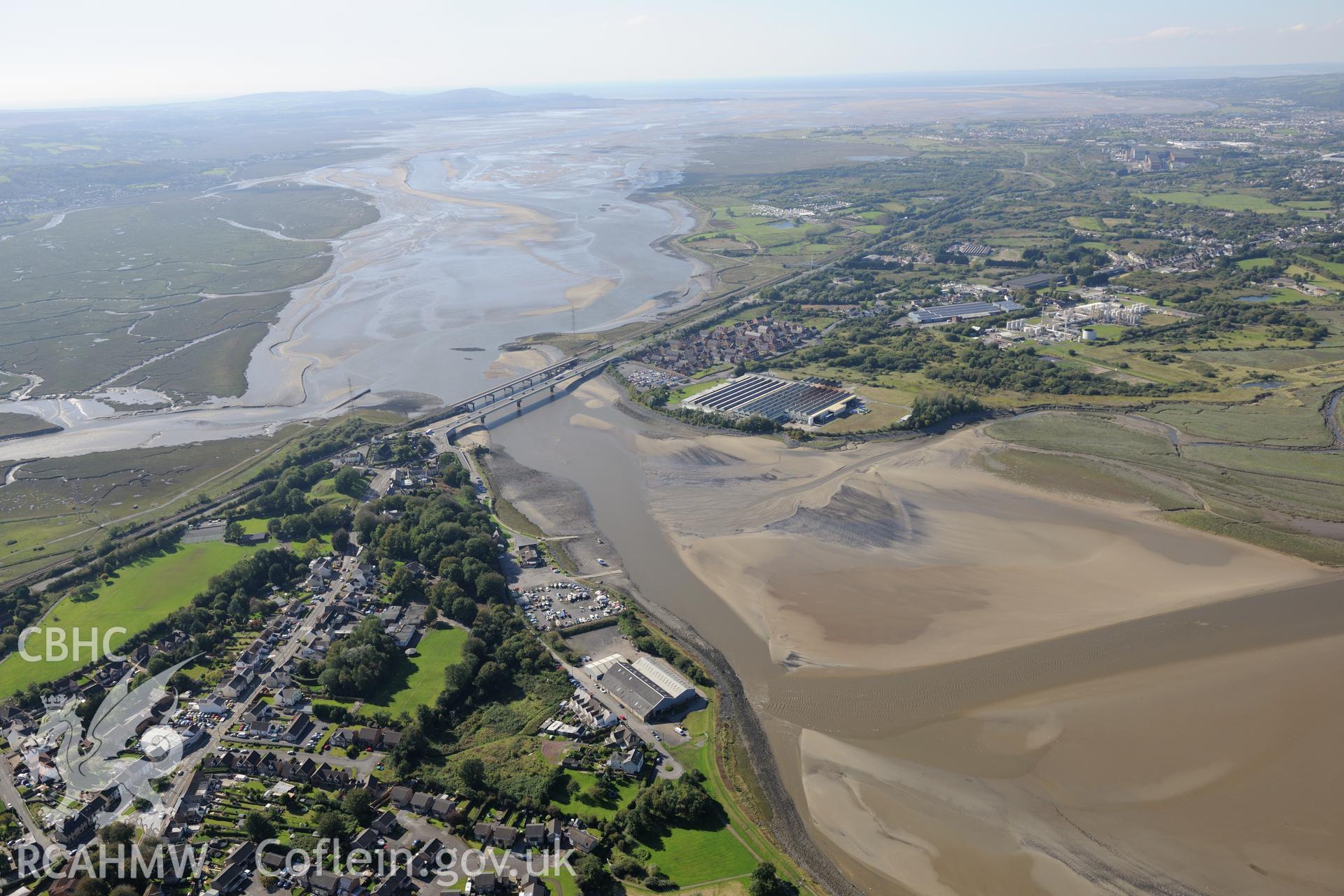 The town of Loughor, between Llanelli and Swansea. View includes Yspytty tin plate works, Loughor road bridge and Loughor railway viaduct. Oblique aerial photograph taken during the Royal Commission's programme of archaeological aerial reconnaissance by Toby Driver on 30th September 2015.