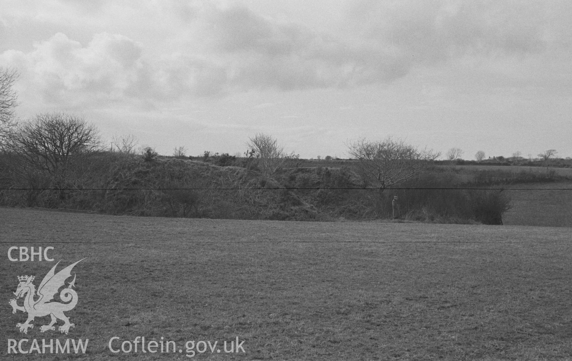 Digital copy of a black and white negative showing Norman motte 100m north east of the site of St Mary's church Llanfair Trefhelygen. Photographed in April 1963 by Arthur O. Chater from Grid Reference SN 3445 4417, looking north north west.