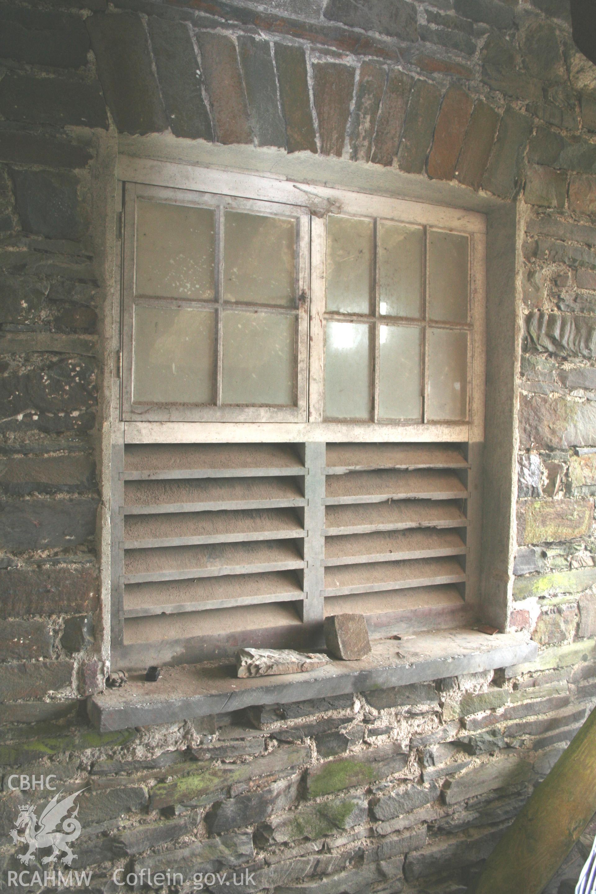 Exterior view of window with grille shutter. Photographic survey of the threshing house, straw house, mixing house and root house at Tan-y-Graig Farm, Llanfarian, conducted by Geoff Ward and John Wiles, 11th December 2006.