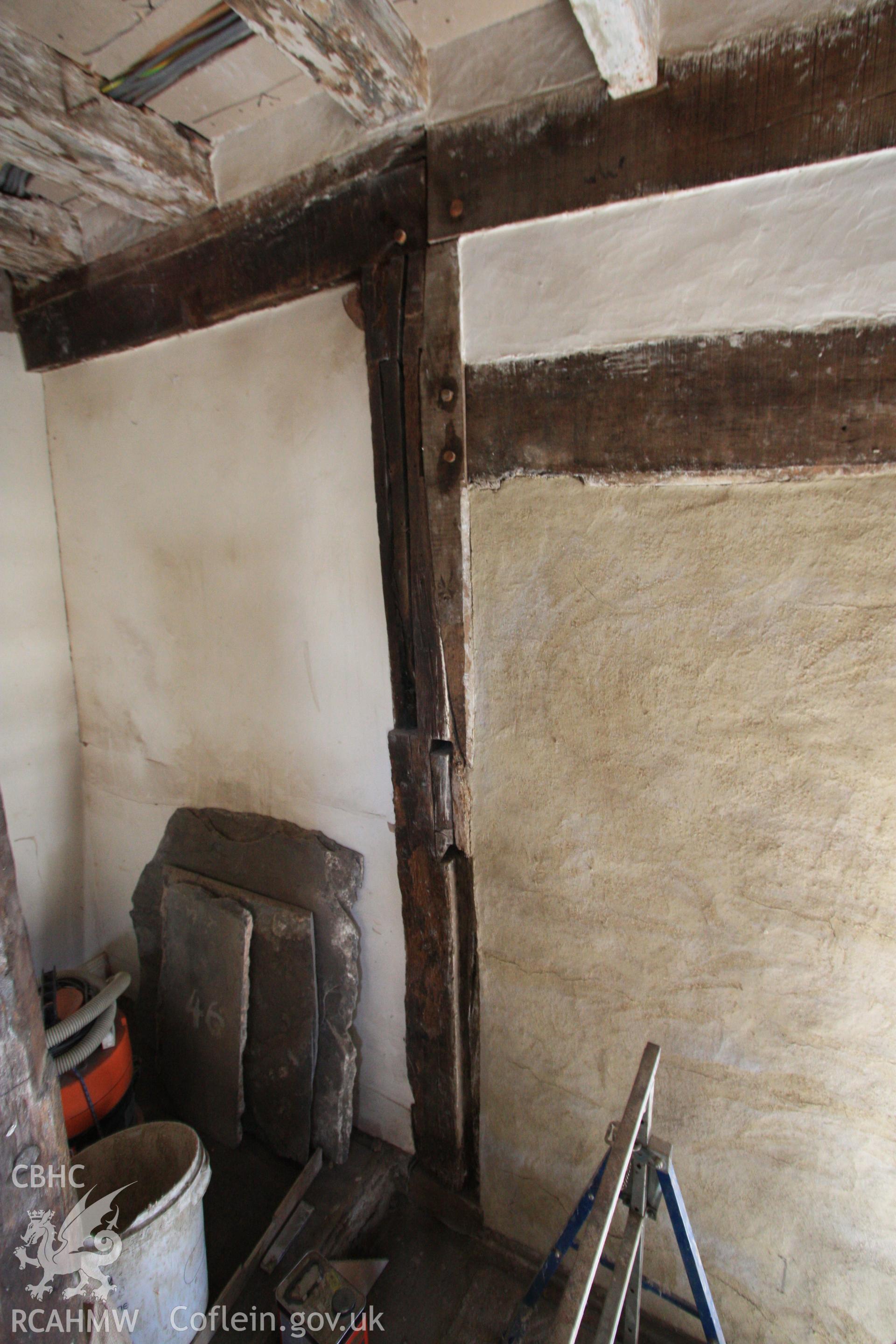 Colour photograph showing interior view of timber frame and plastered wall at Porth-y-Dwr, 67 Clwyd Street, Ruthin. Photographed during survey conducted by Geoff Ward on 10th June 2013.