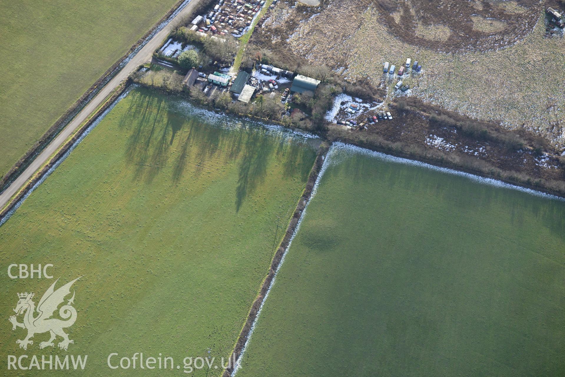 Pant y Menyn round barrow on the southern outskirts of Glandy Cross, near Narberth. Oblique aerial photograph taken during the Royal Commission's programme of archaeological aerial reconnaissance by Toby Driver on 4th February 2015.