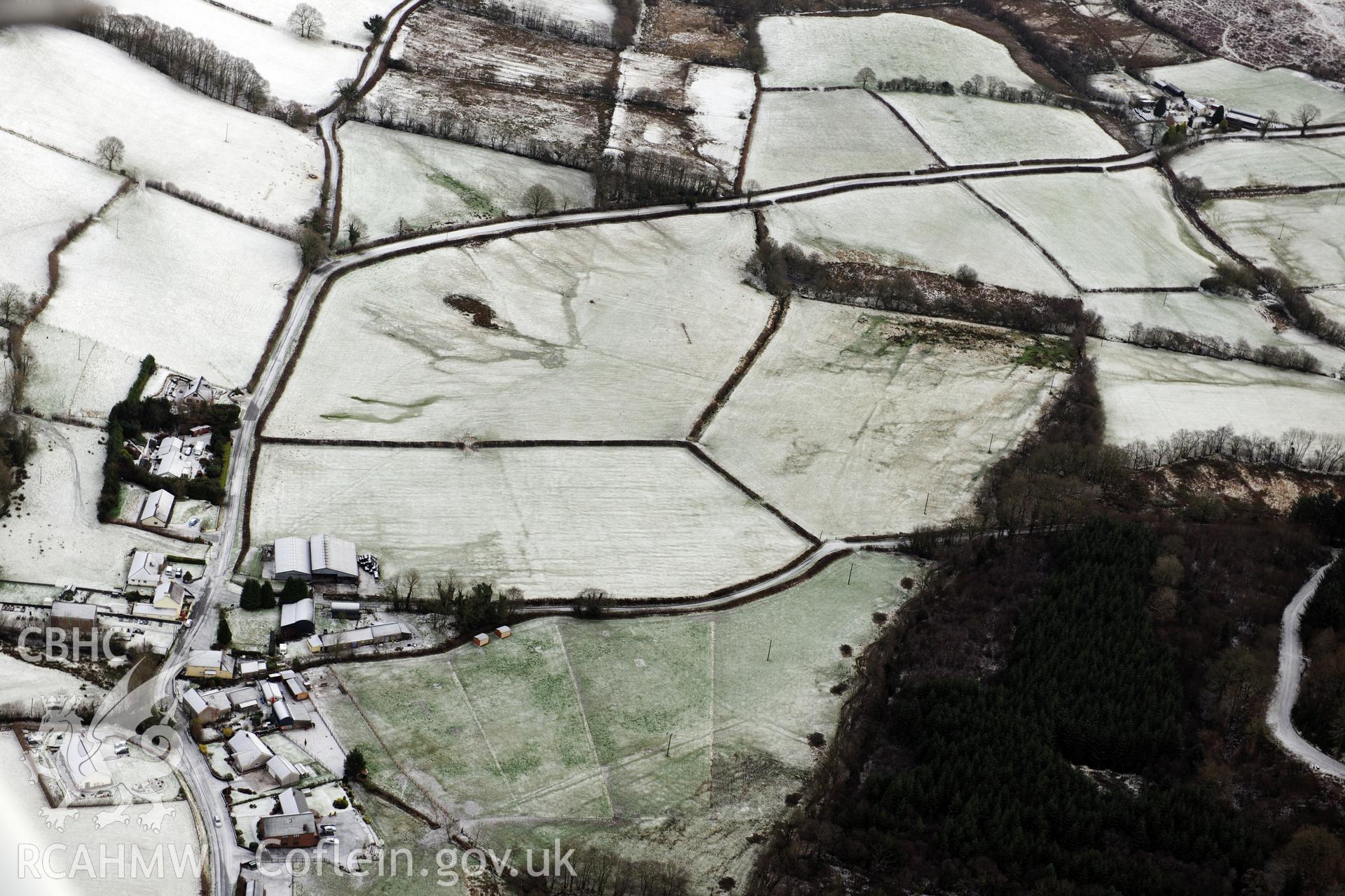 Earthworks and cropmarks of a Roman road, east of Porthyrhyd, north west of Llandovery. Oblique aerial photograph taken during the Royal Commission?s programme of archaeological aerial reconnaissance by Toby Driver on 15th January 2013.