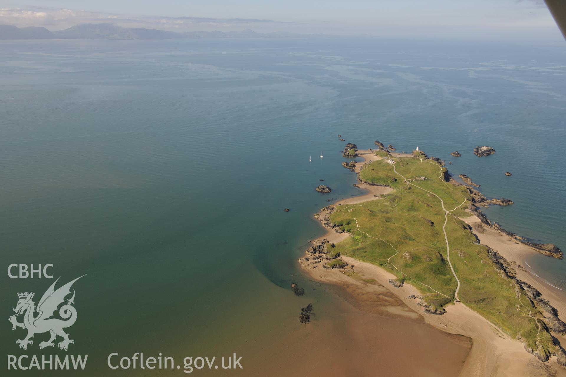 The lighthouse, pilot's house and St. Dwynwen's Church on Llanddwyn Island. Oblique aerial photograph taken during the Royal Commission's programme of archaeological aerial reconnaissance by Toby Driver on 23rd June 2015.
