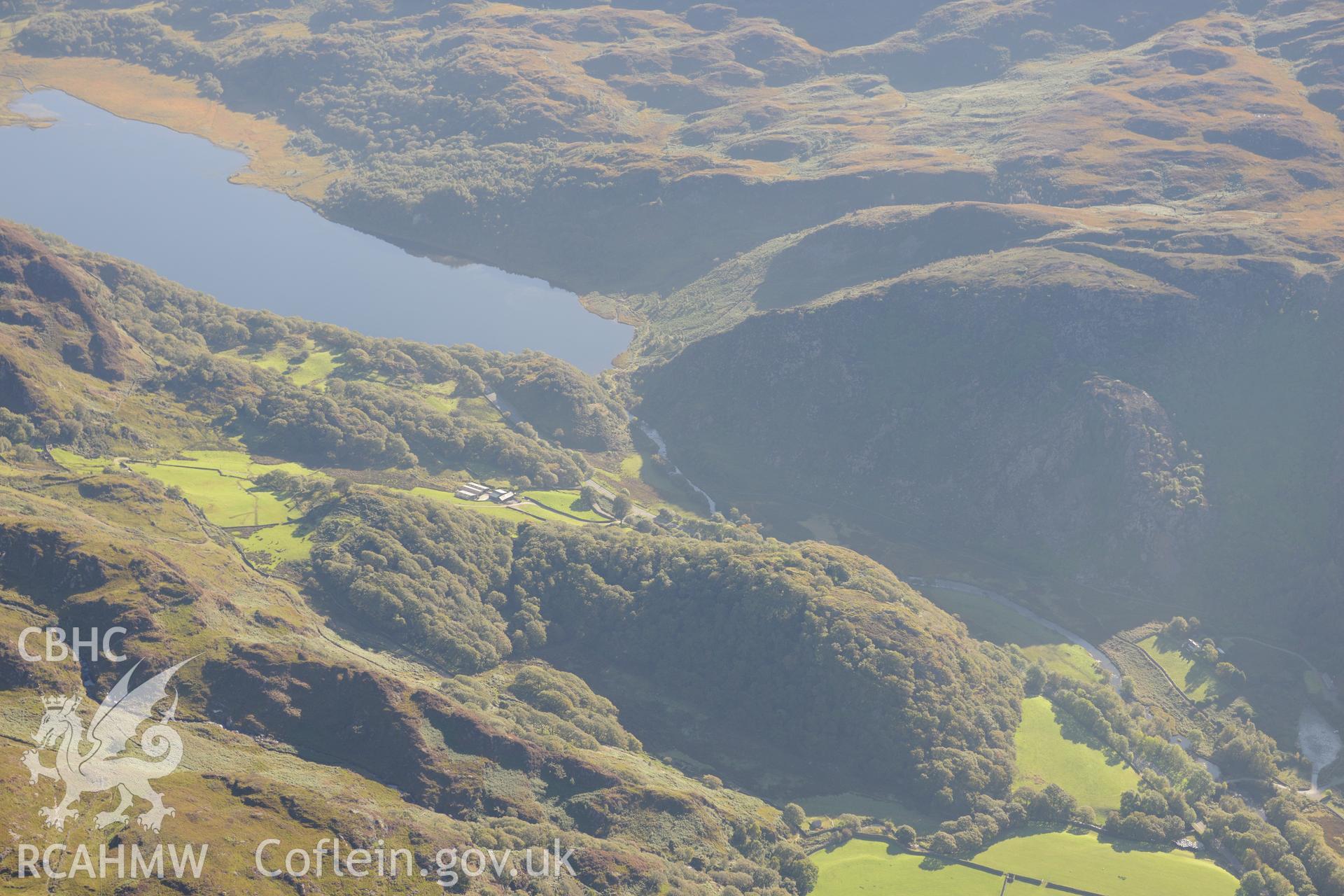 Dinas Emrys hillfort and Llyn Dinas near Beddgelert. Oblique aerial photograph taken during the Royal Commission's programme of archaeological aerial reconnaissance by Toby Driver on 2nd October 2015.