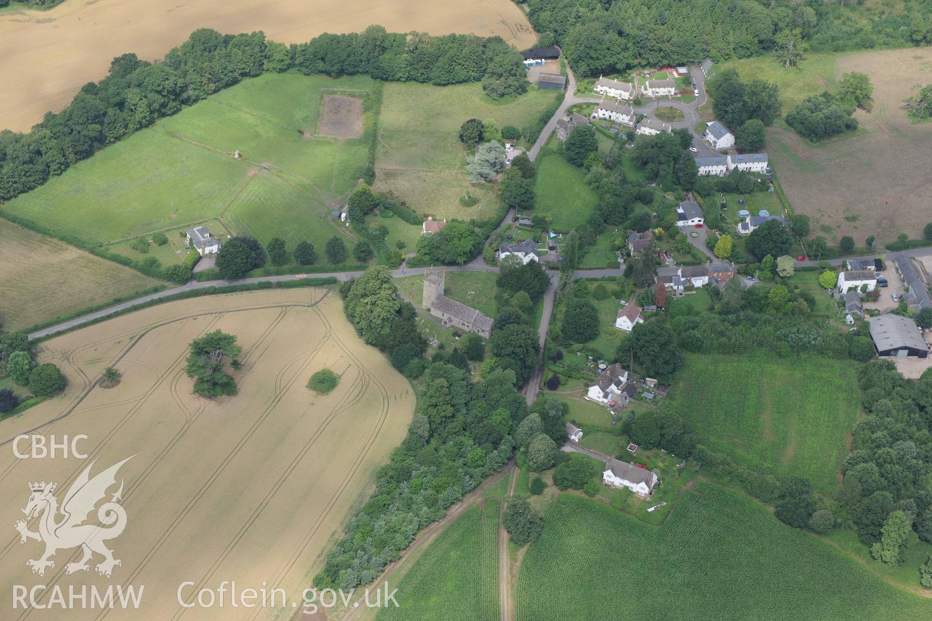 St. Teilo's church with the cross in the southern part of its churchyard, Llanarth, between Abergavenny and Monmouth. Oblique aerial photograph taken during the Royal Commission?s programme of archaeological aerial reconnaissance by Toby Driver on 1st August 2013.