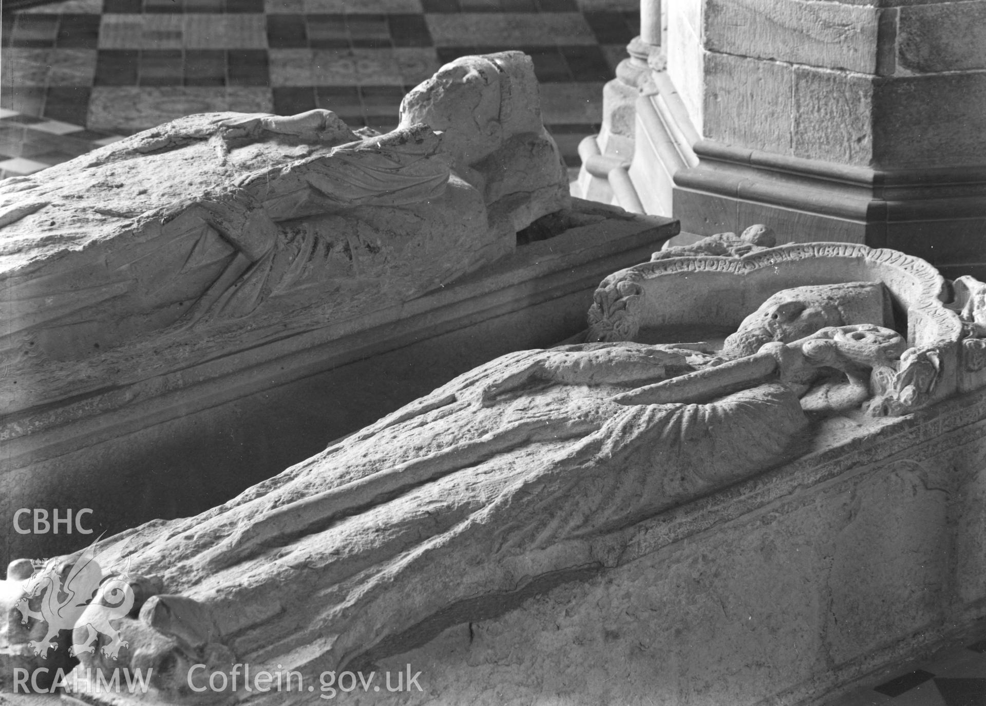 Digital copy of a black and white nitrate negative showing view of effigies on tombs at St. David's Cathedral, taken by E.W. Lovegrove, July 1936.
