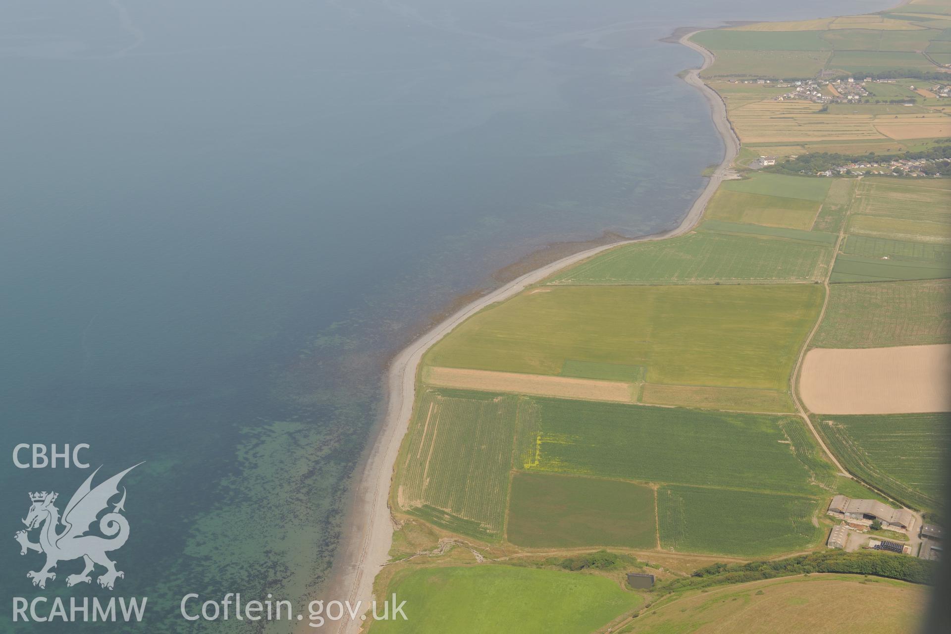 Aberarth village with Aberarth fish trap complex just off the shore. Oblique aerial photograph taken during the Royal Commission?s programme of archaeological aerial reconnaissance by Toby Driver on 12th July 2013.