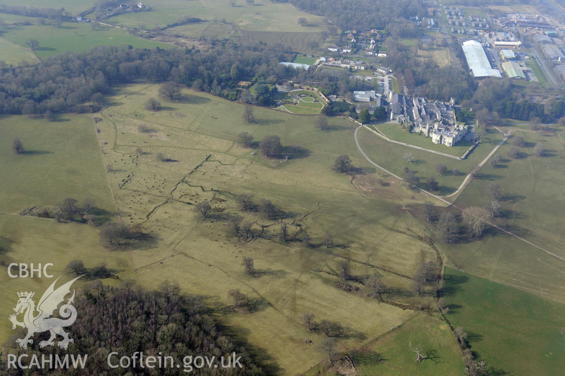 Bodelwyddan Castle, its garden, and Bodelwyddan Park army practise trenches, west of St. Asaph. Oblique aerial photograph taken during the Royal Commission?s programme of archaeological aerial reconnaissance by Toby Driver on 28th February 2013.