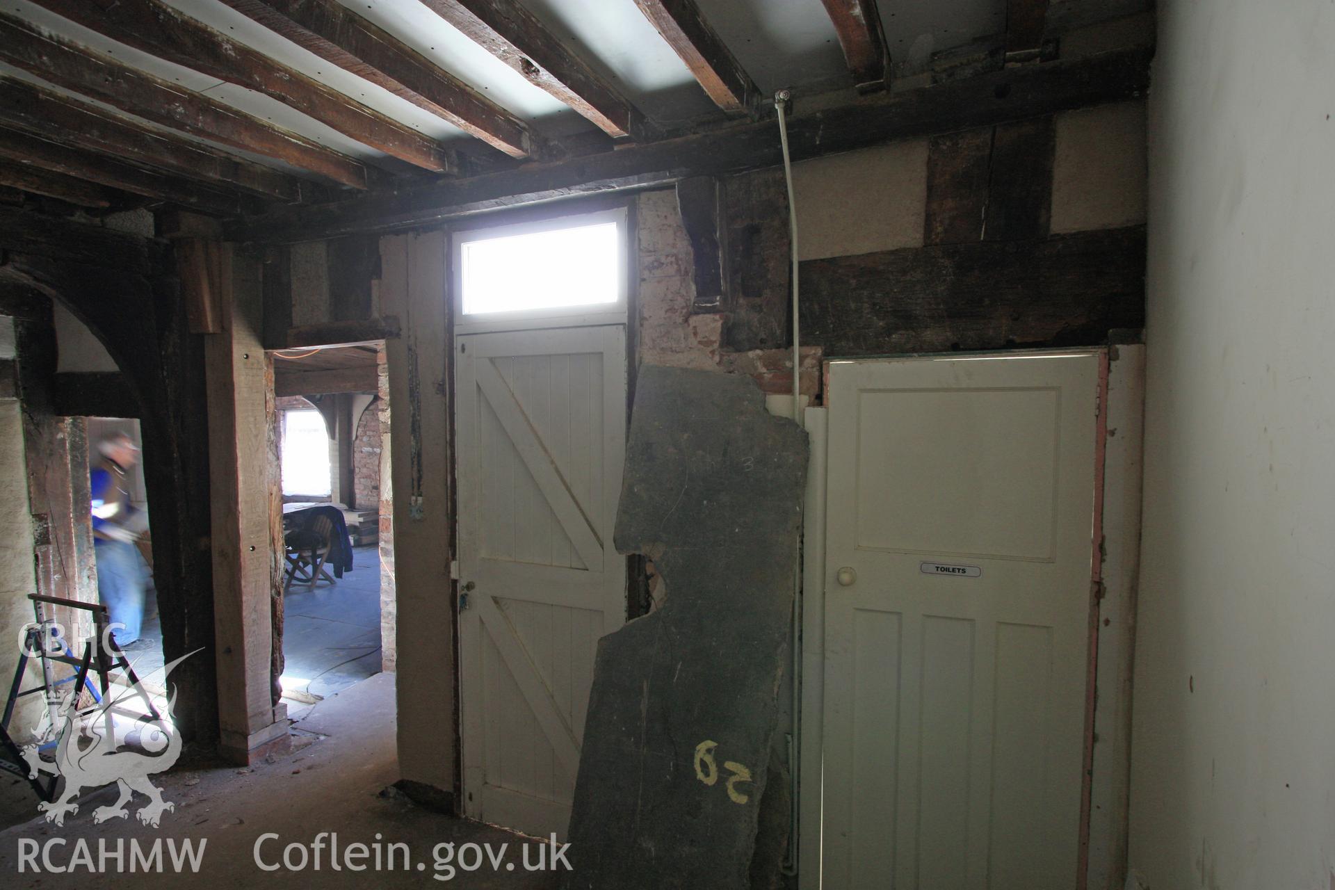 Colour photograph showing remains of midrail and studs, with 17th century bracket and beam at Porth-y-Dwr, 67 Clwyd Street, Ruthin. Photographed during survey conducted by Geoff Ward on 10th June 2013.